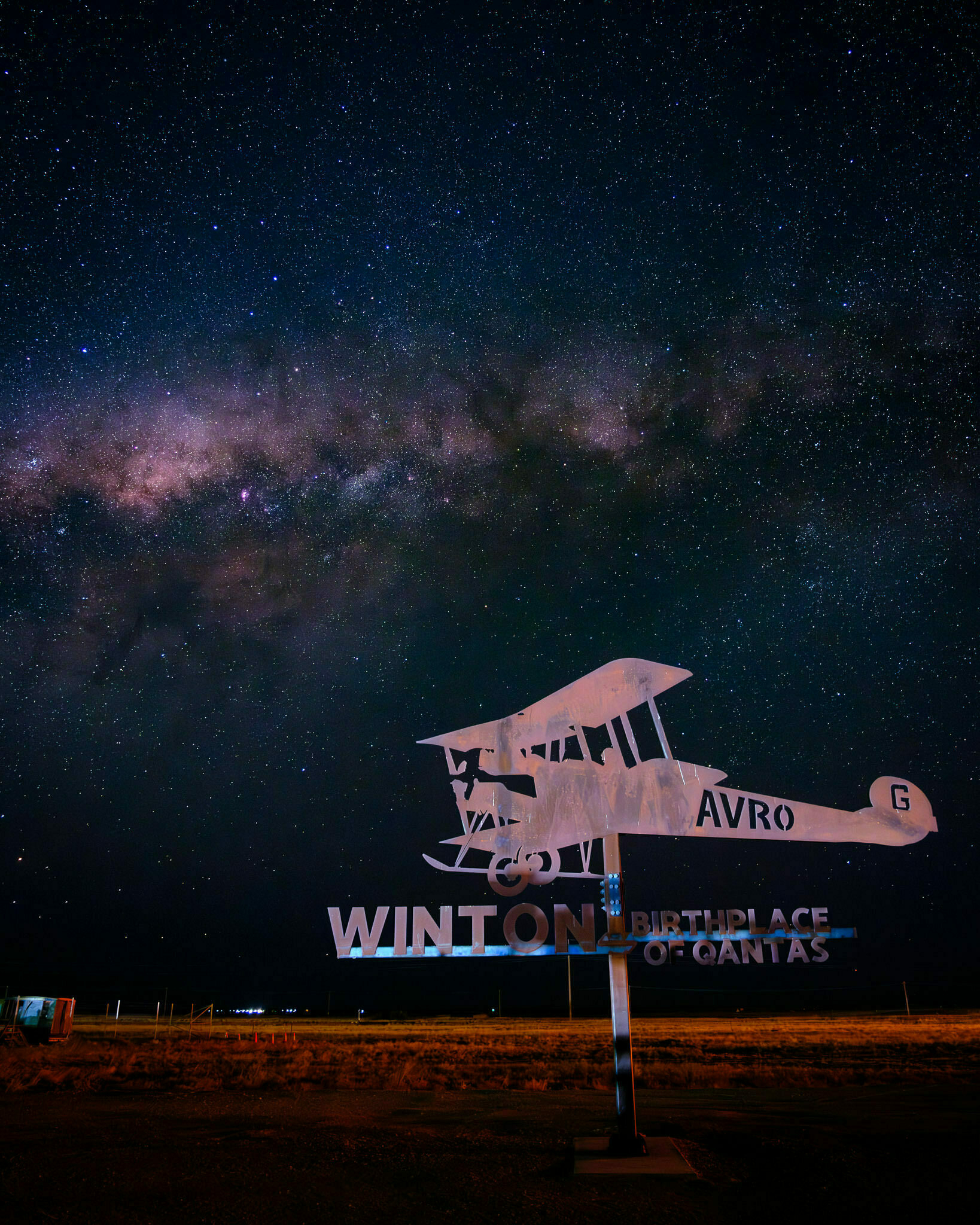 A nightscape image of a monument to the founding of Qantas in Winton, Queensland, wiht the Milky Way in the background.