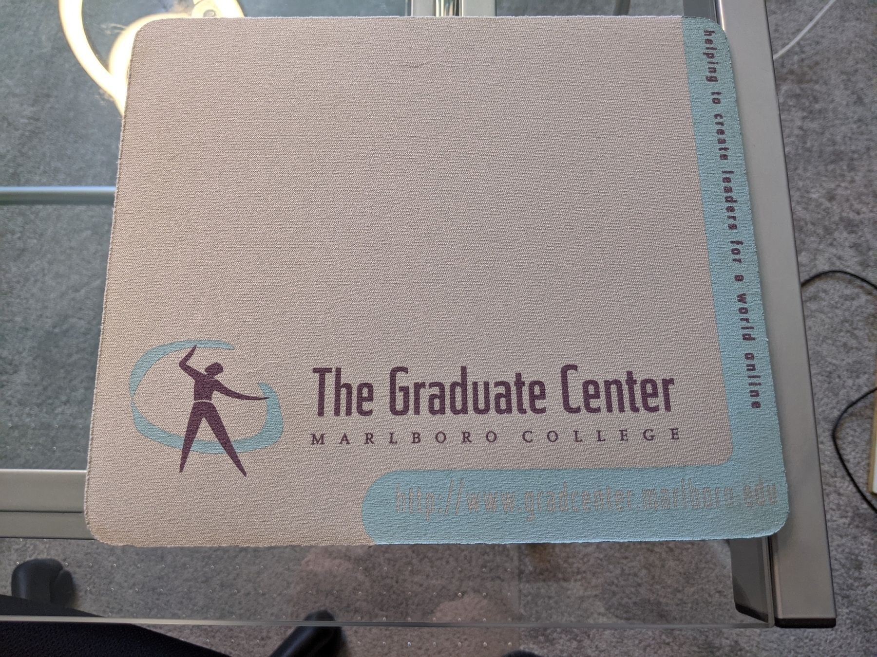 Mousepad that says Graduate Center at Marlboro College, helping to create leaders for a world online. 