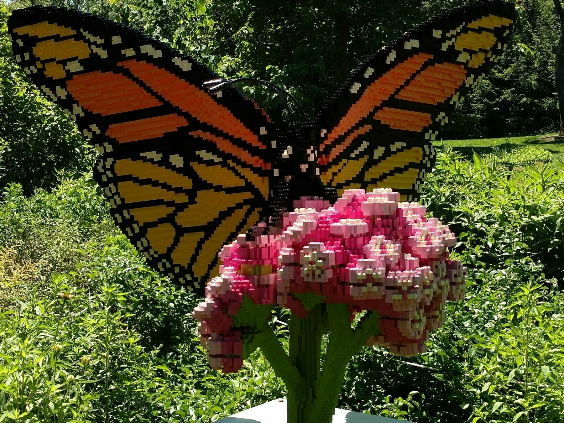 6 foot tall sculpture of monarch butterfly on a flower