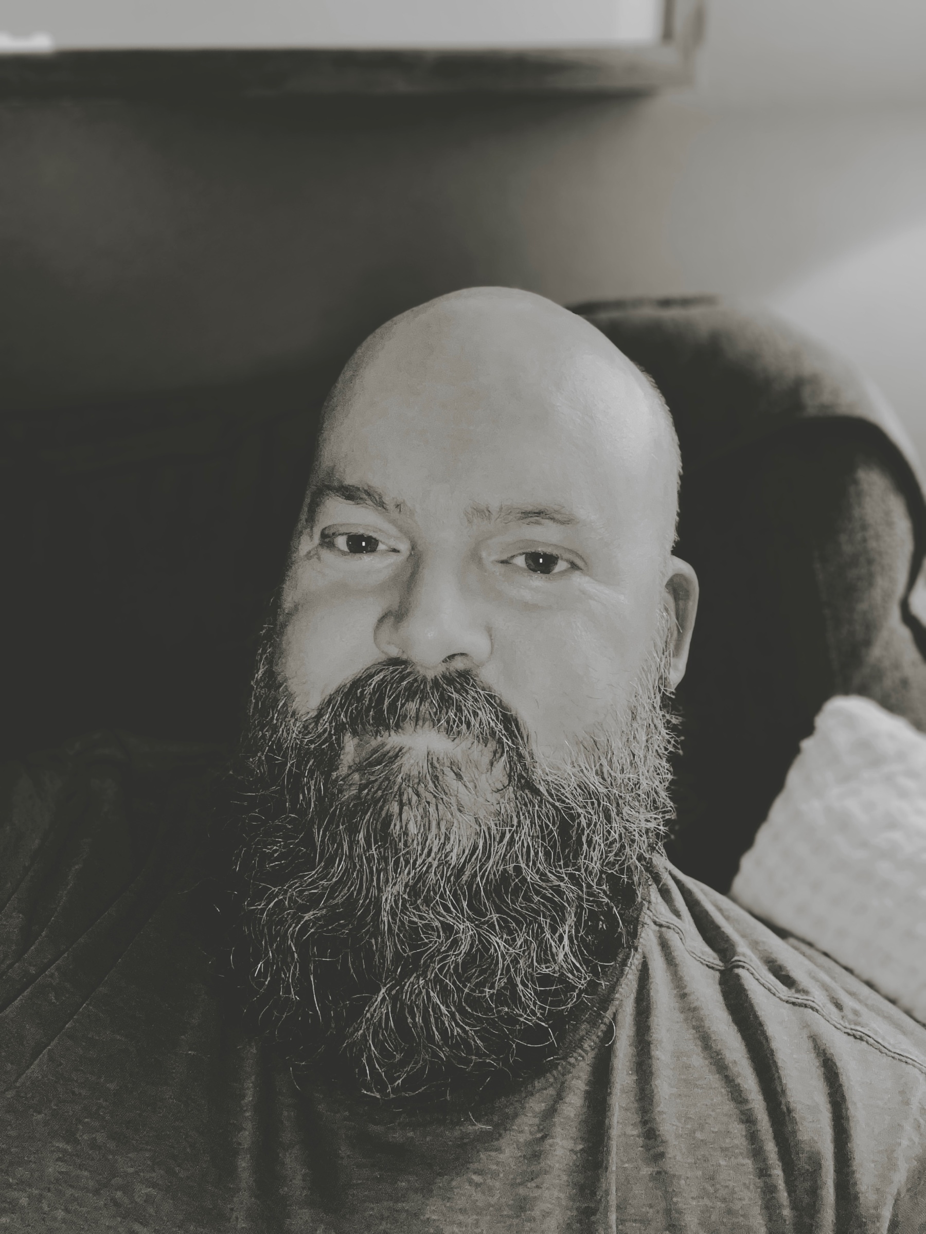 Black and white selfie of me sitting on the couch after showering and fixing up my beard. Too bad it won’t last…