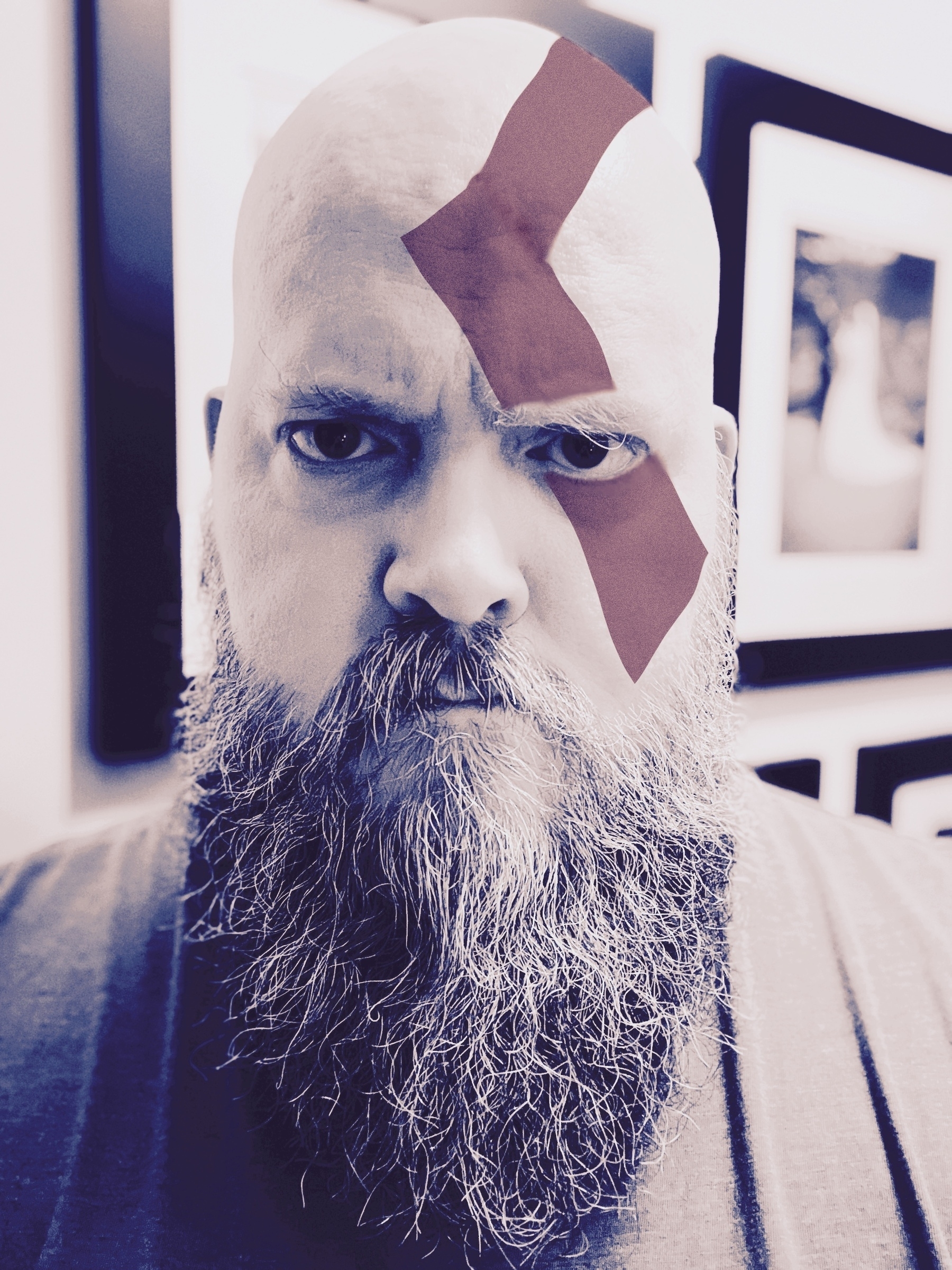 Portrait of me with a beard in the style of Kratos, from the God Of War video game. My head is shaved clean (of course), and I've digitally added the dark red stripe of face paint on my face to match Kratos as well.