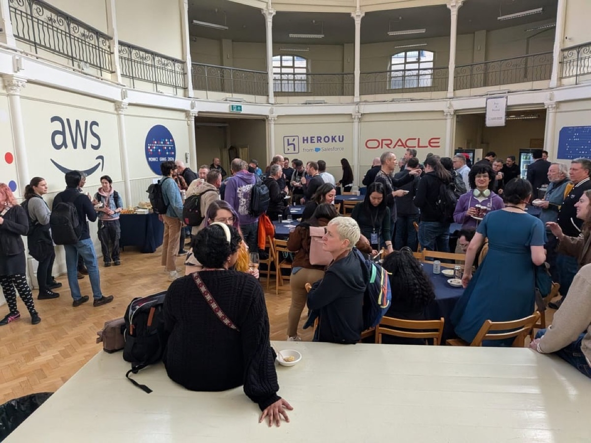 A crowd at Monkigras 2026 - small developer conference - listening to a speaker.