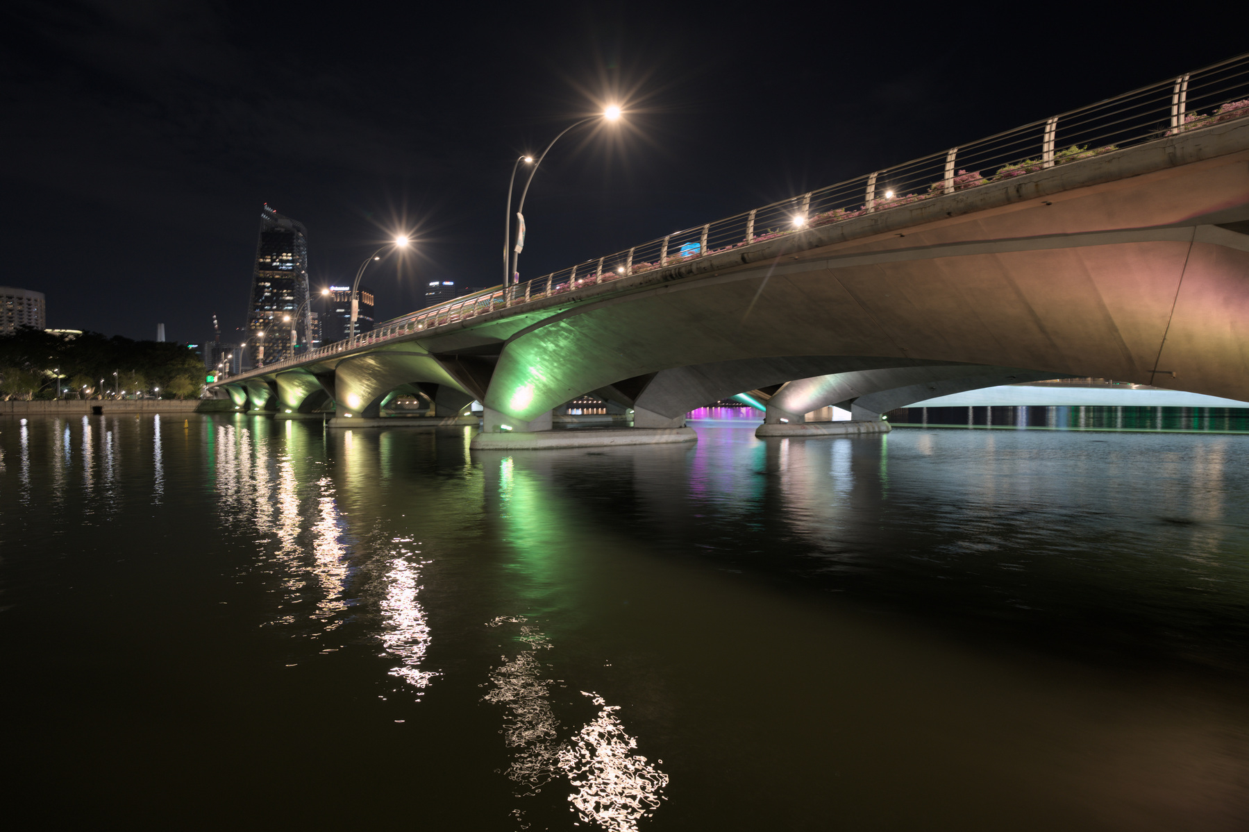 A bridge across the water of the Singapore river. The water is choppier from the shorter exposure time.