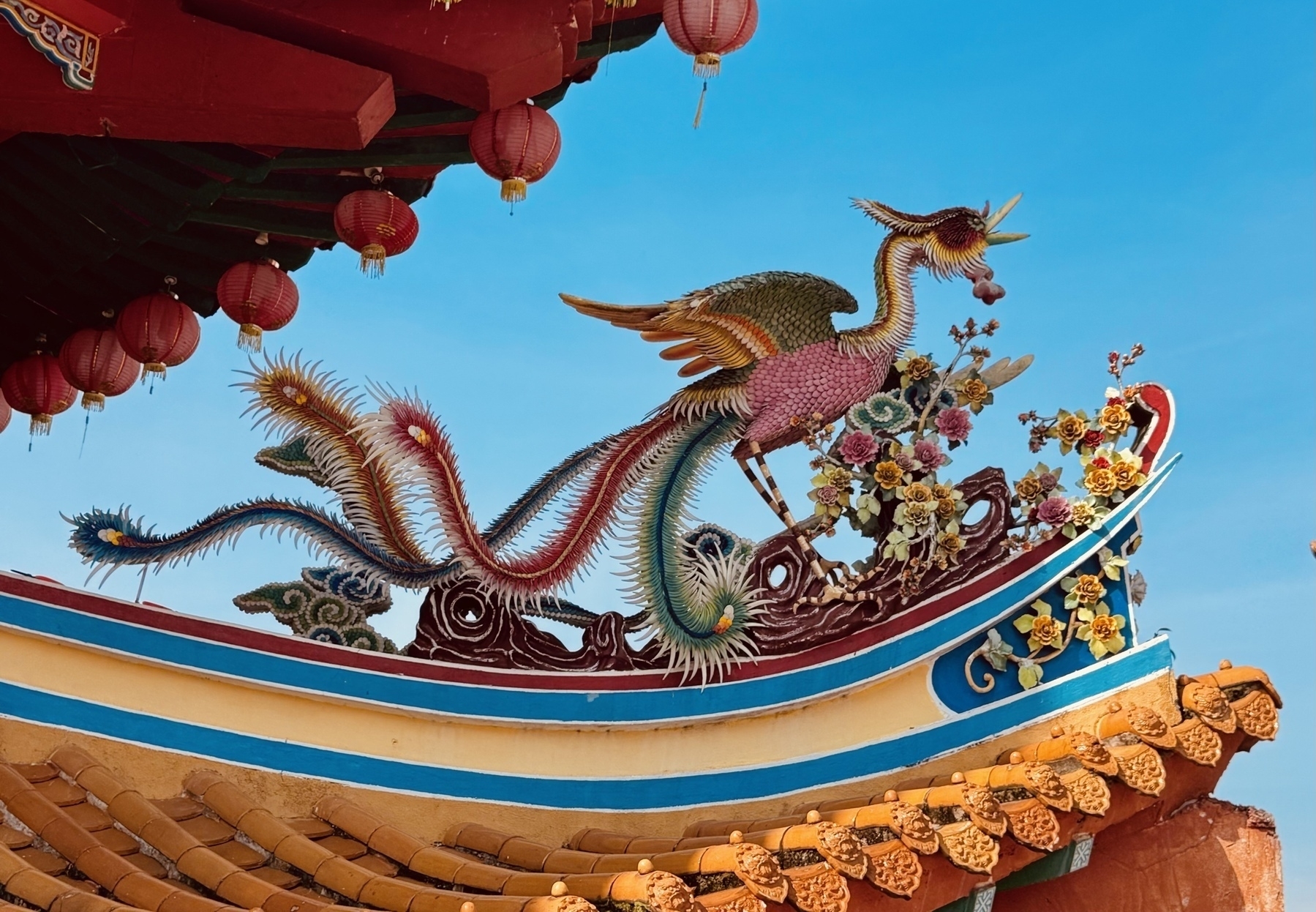 A phoenix poised on the temple roof