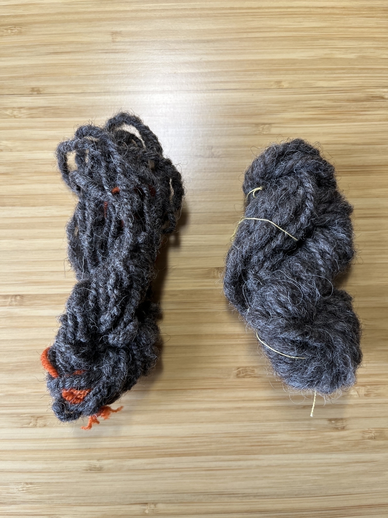 Two skeins of grey hand-spun yarn