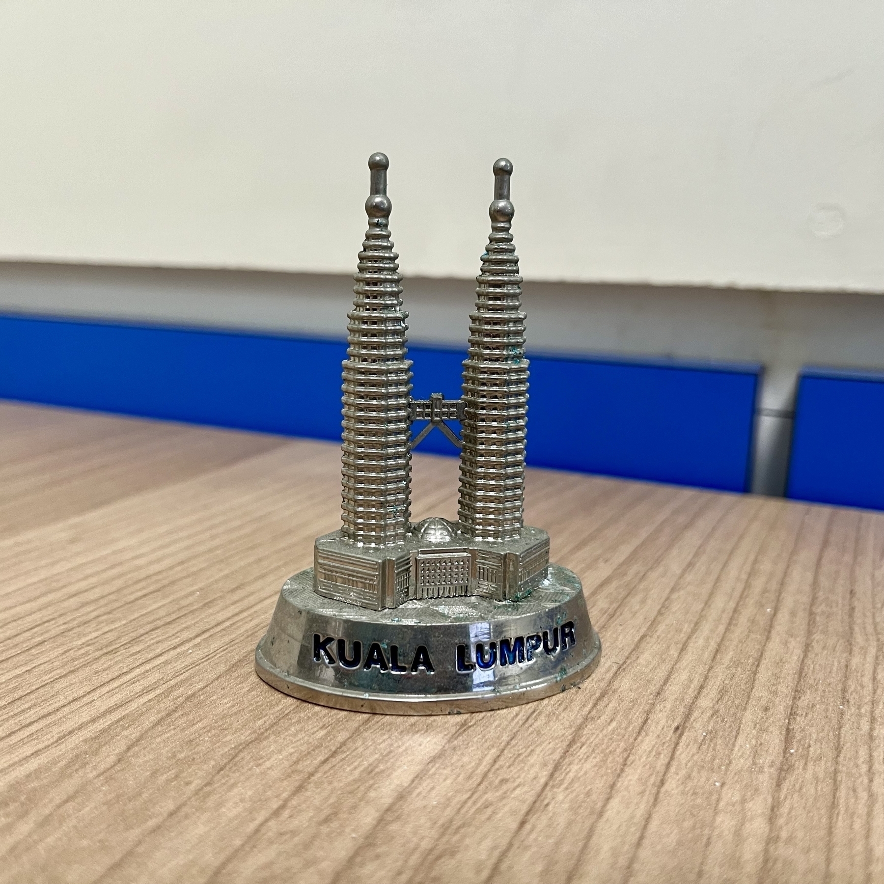 A tiny metal model of the Petronas Towers in Kuala Lumpur. 