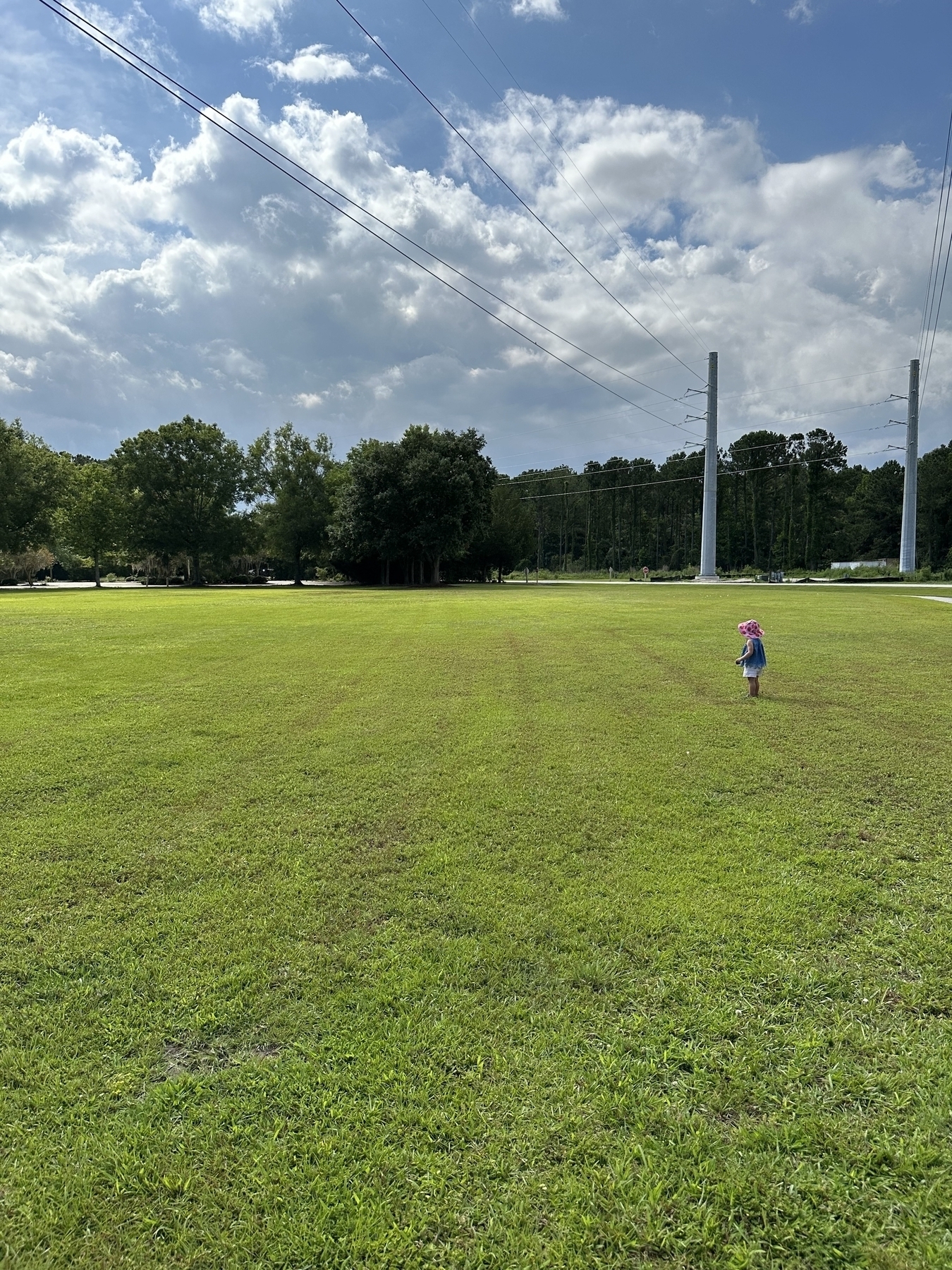 My daughter in the middle of a field in a county park. 