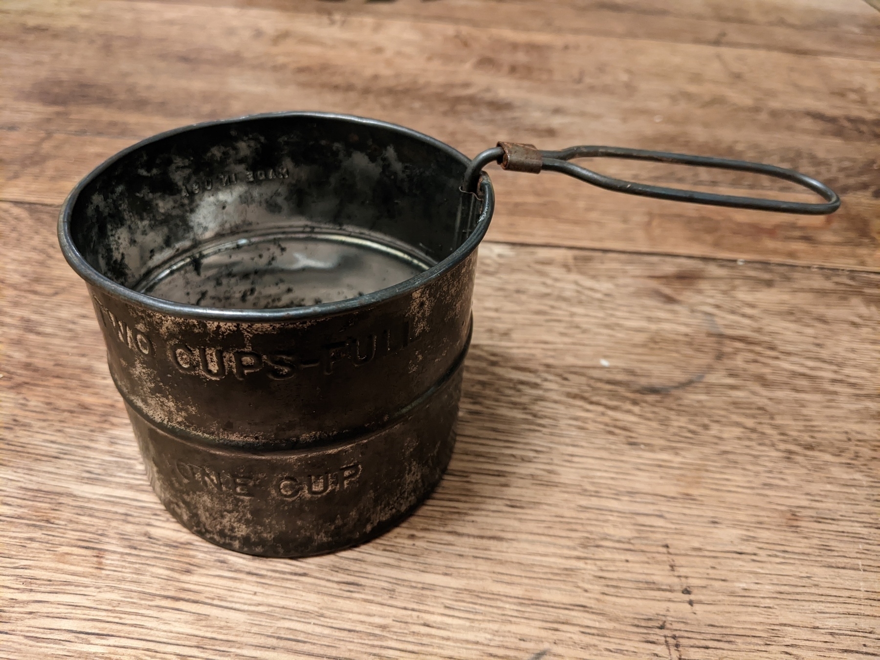 side view of vintage sifter showing one cup and two cup marks
