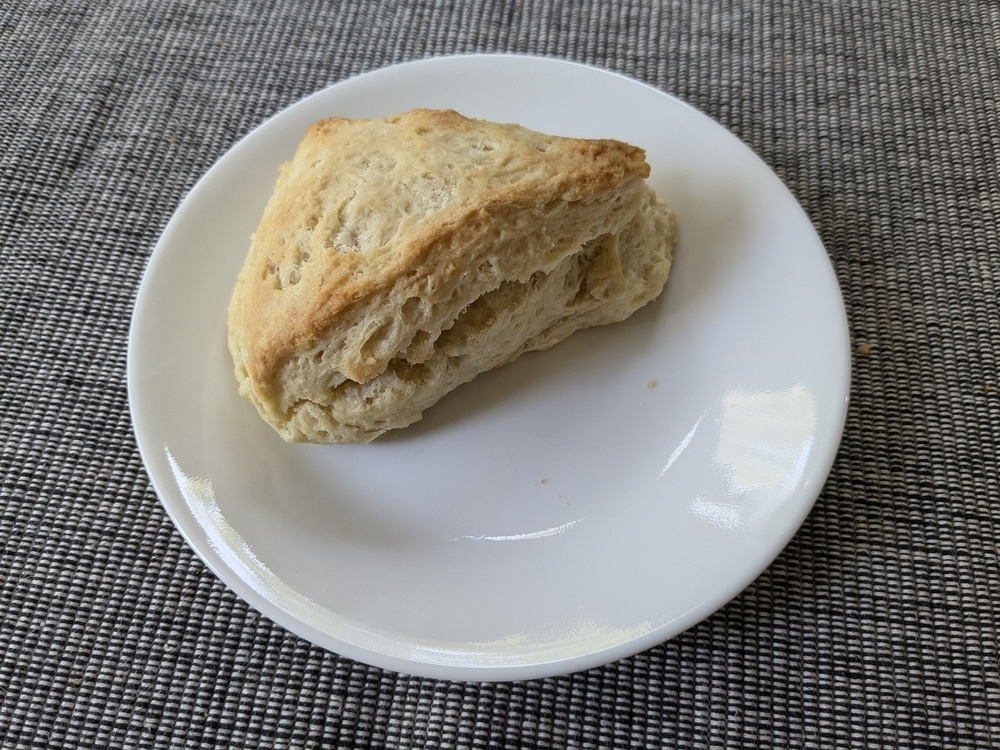 puffy wedge scone on a plate, the top nicely browned