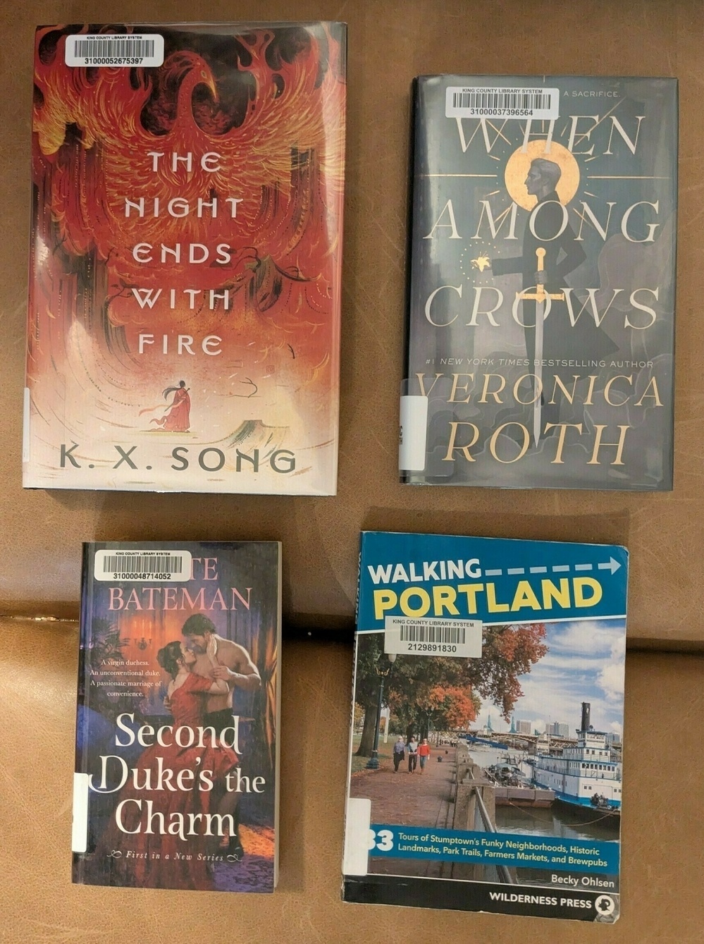 flatlay of two novels, a novella and a travel guide