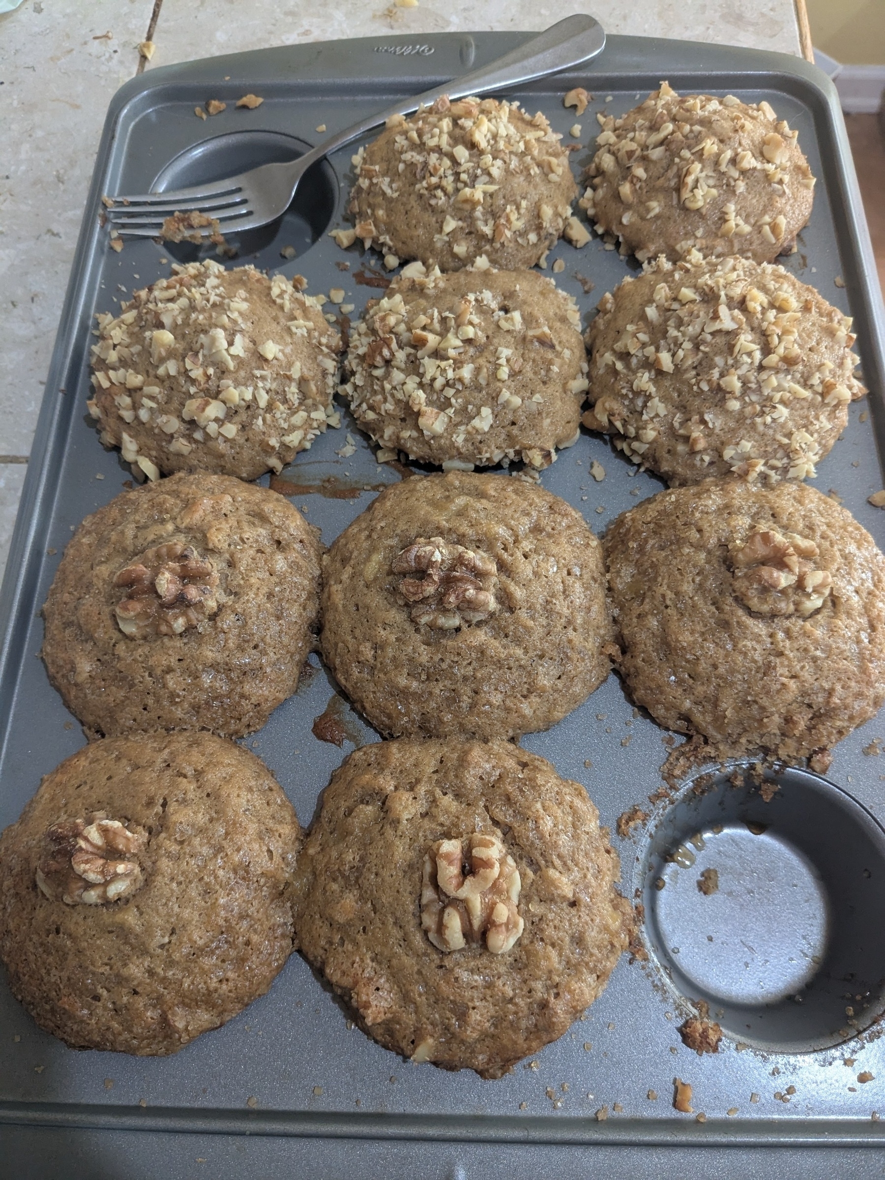 tray of muffins with two toppings, one muffin of each kind missing 