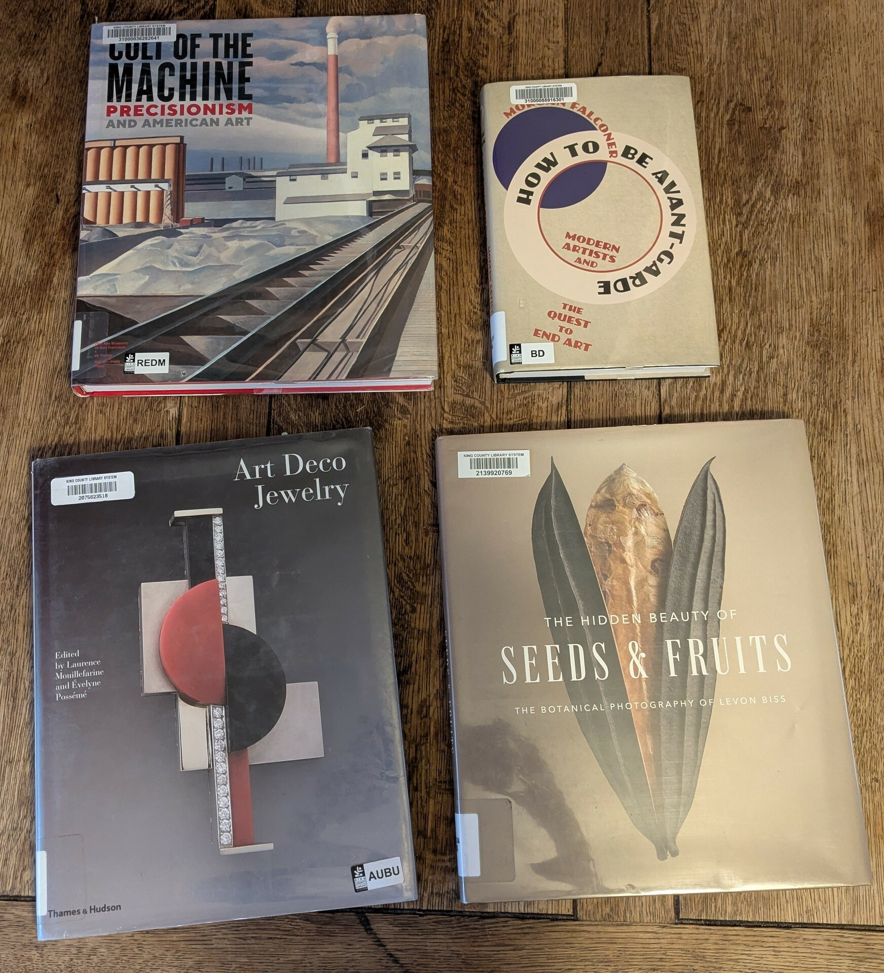 flatlay of three oversize art books and one prose book about art