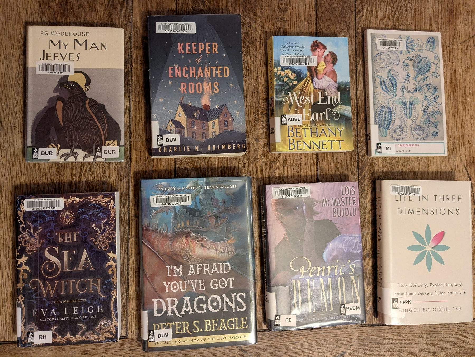 flatlay of 7 fiction books - 5 specific and two historical fiction - and one self-help-y nonfiction book