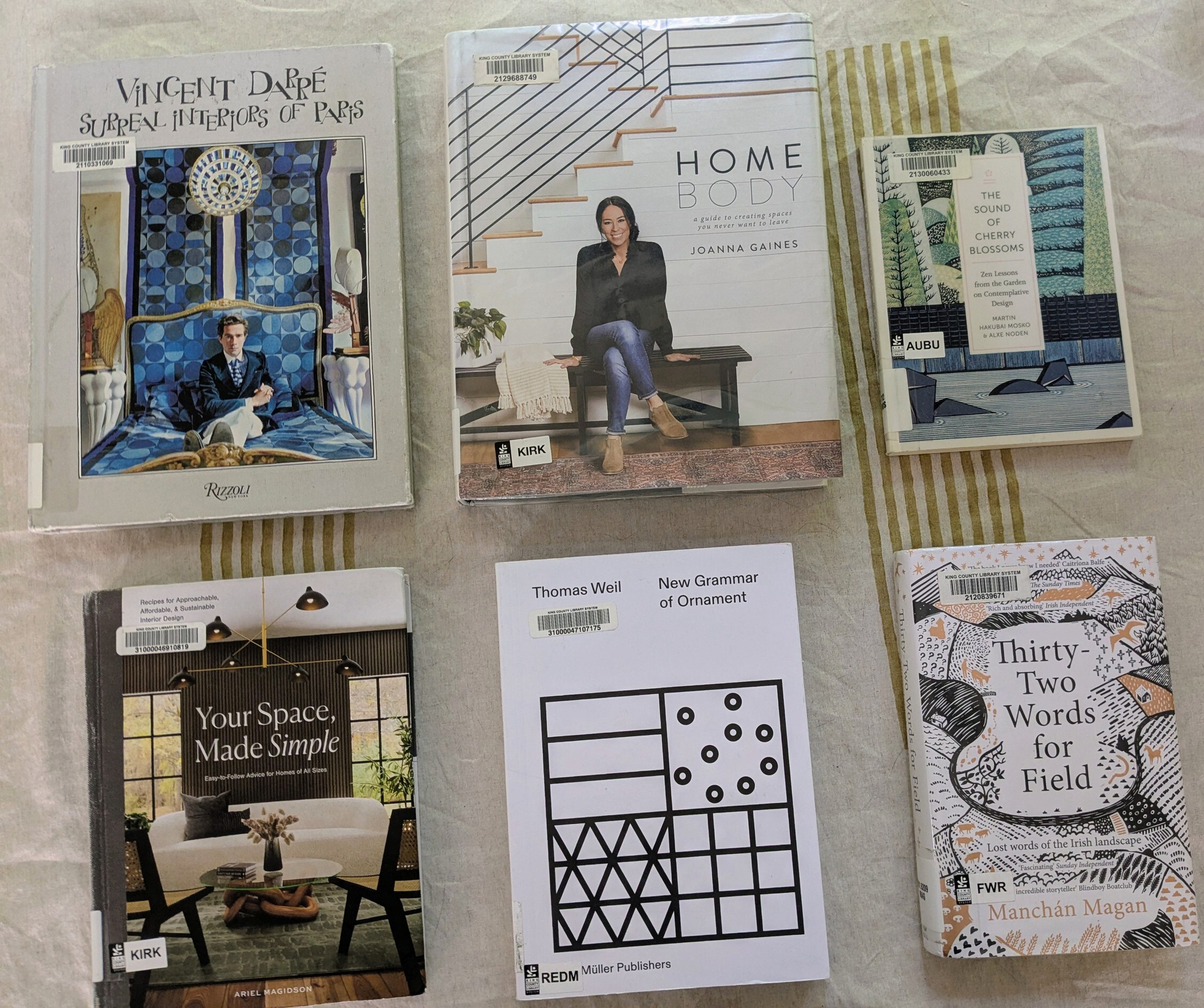 flatlay of two coffee table books, two art books, and two nonfiction books
