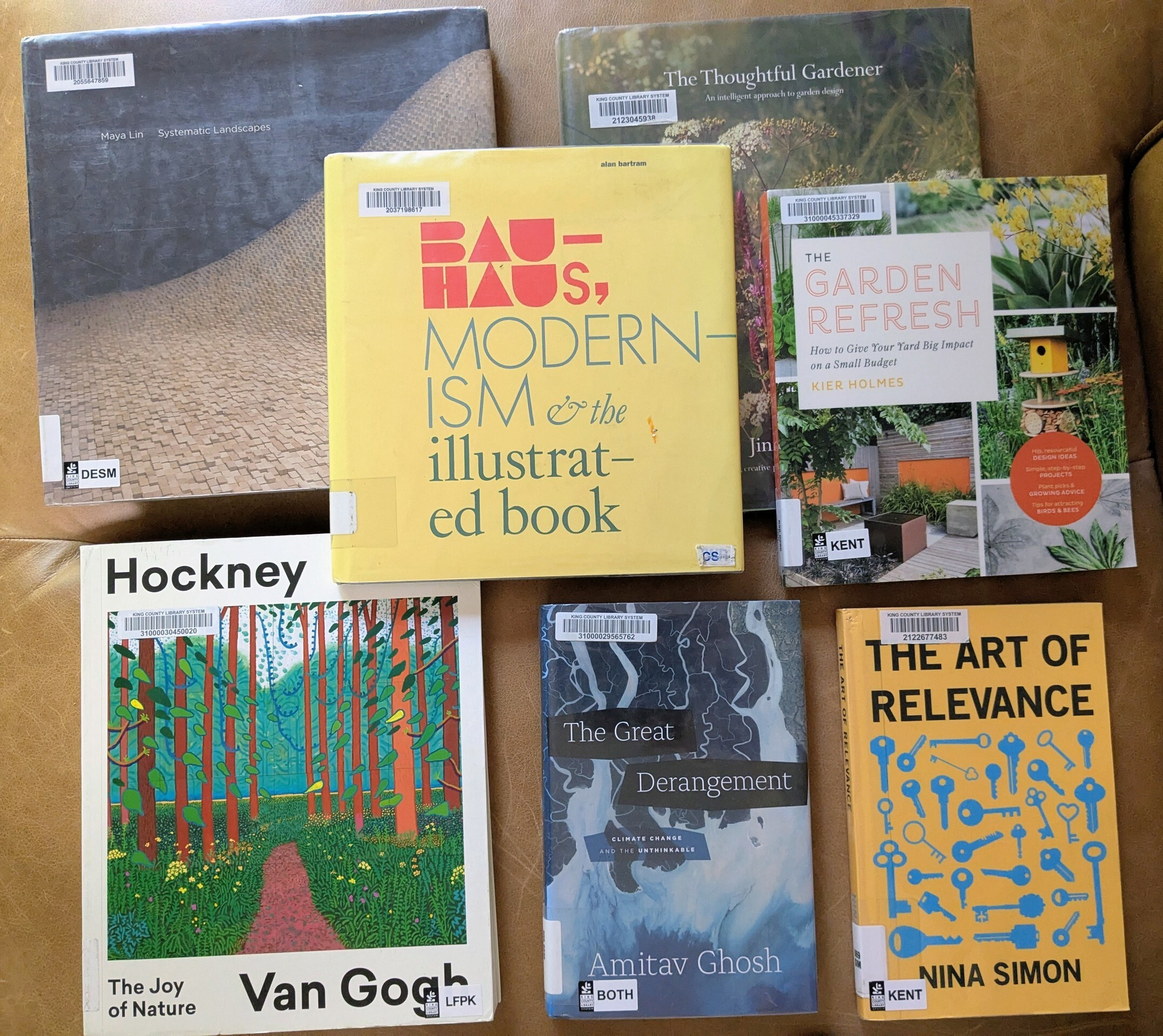 flatlay of seven books, some overlapping, five of them large coffee table books