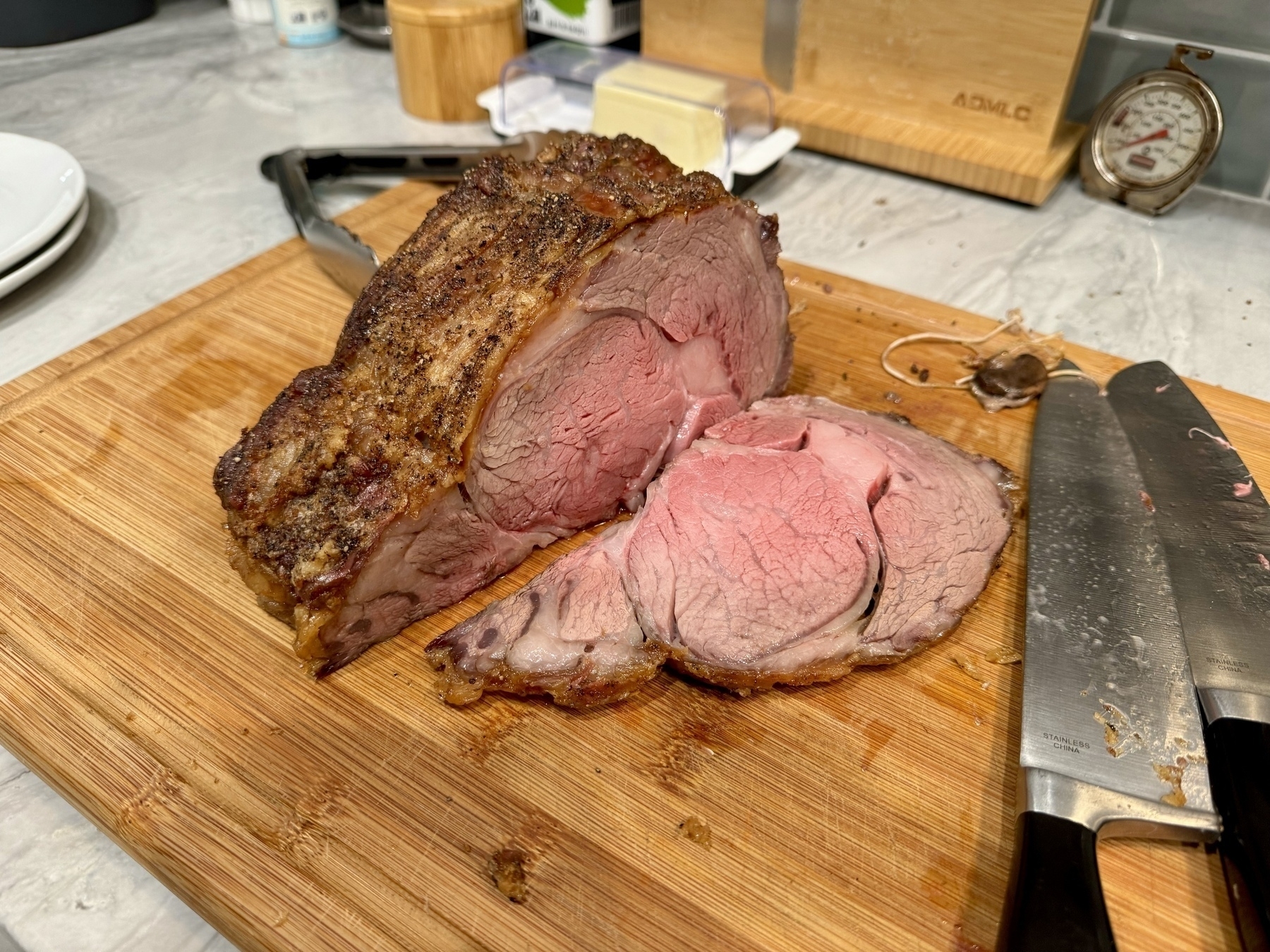 A standing rib roast with the end sliced off so that the inside shows a light pink in the center. 