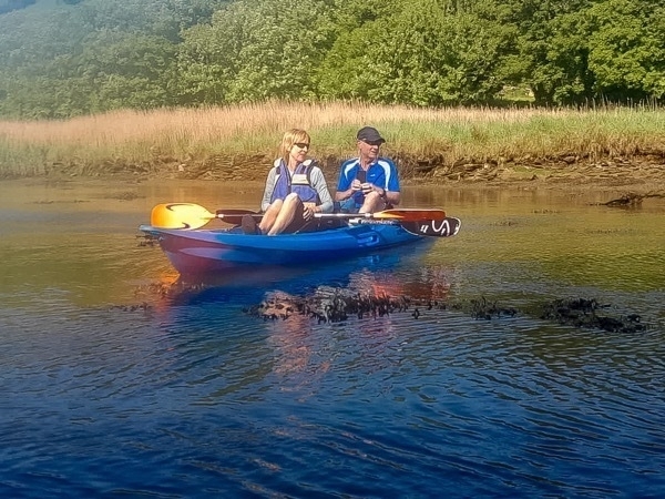 two people in a blue kayak
