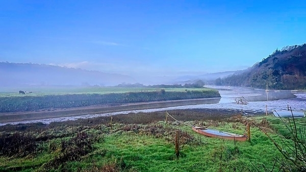 a photo of early morning mist above the estuary