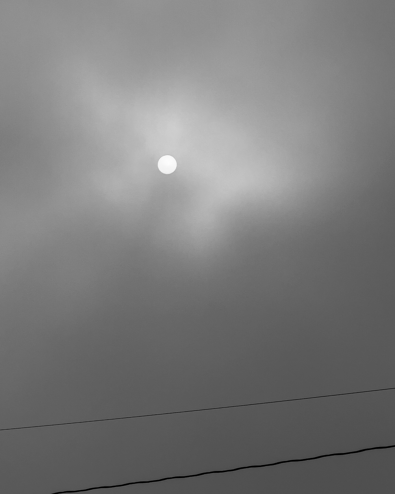 the sun in a cloudy sky
