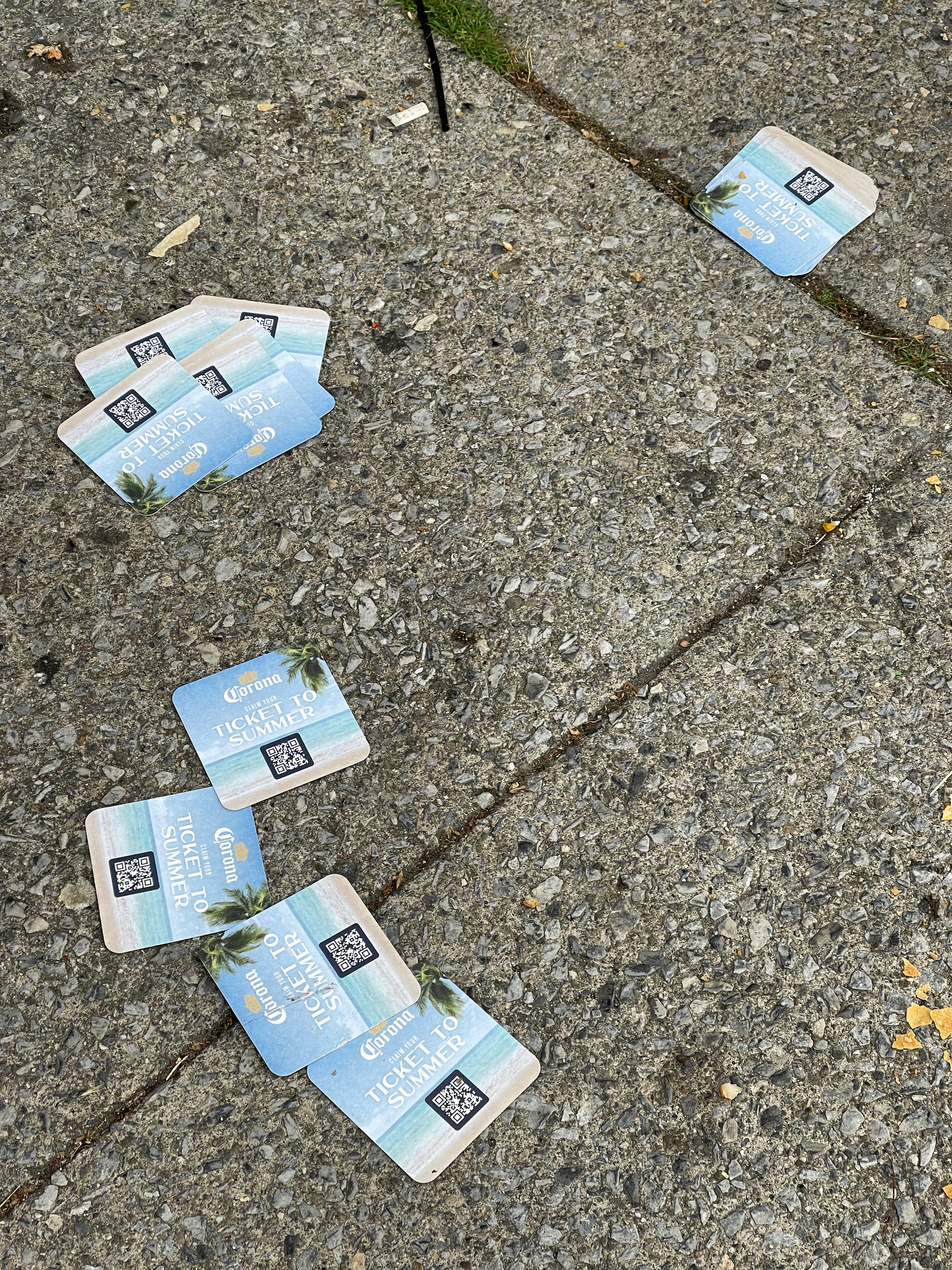 Corona beer cards strewn across the pavement.