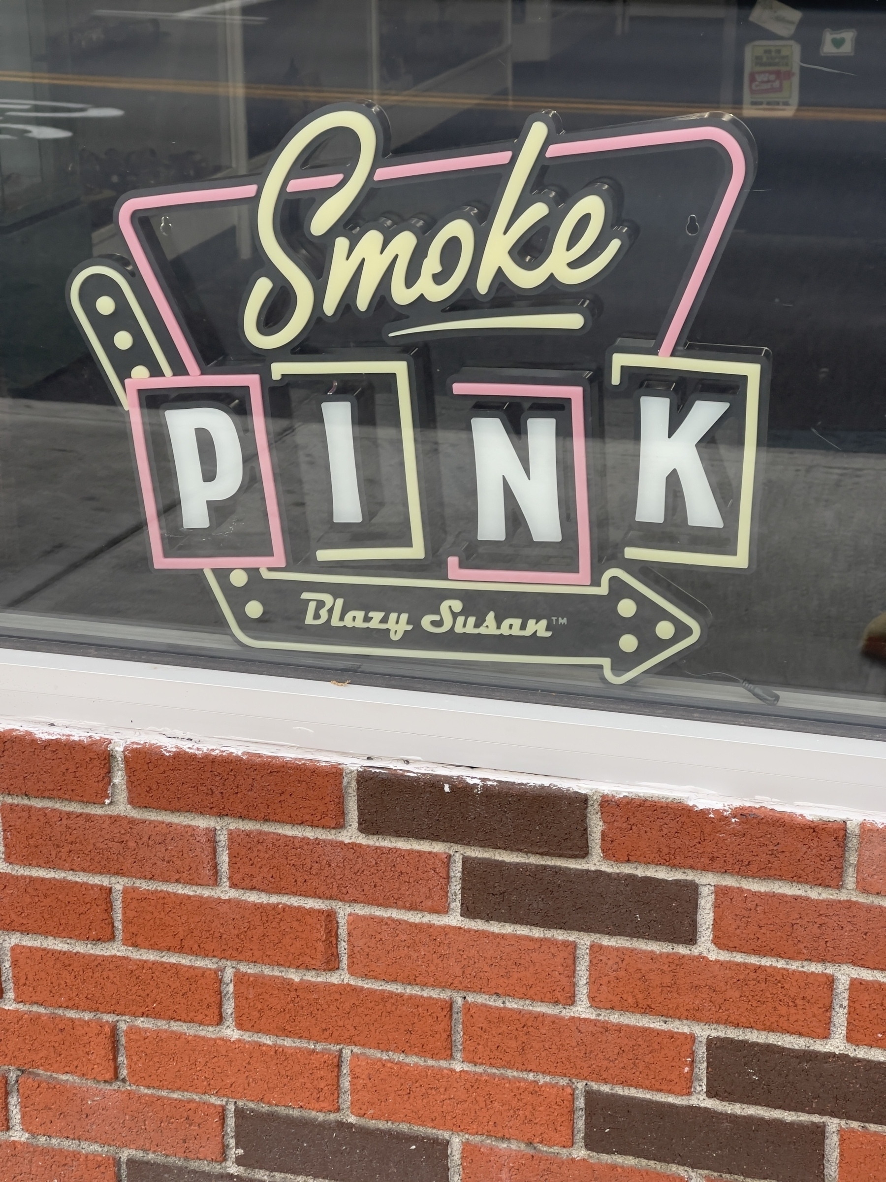 Retro “Smoke Pink” sign in shop window.
