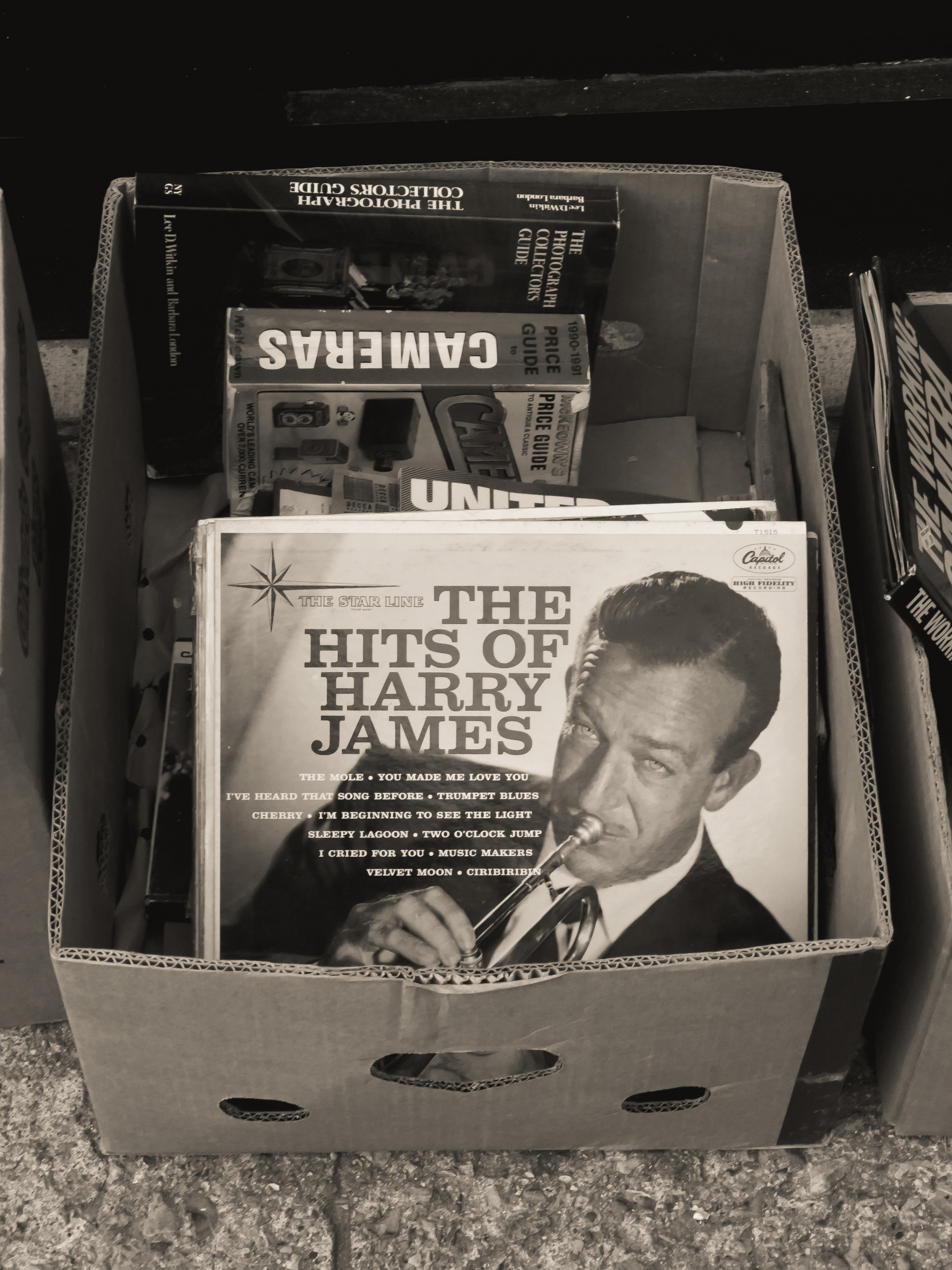 The Hits of Harry James vinyl record album in a box outside a shop.