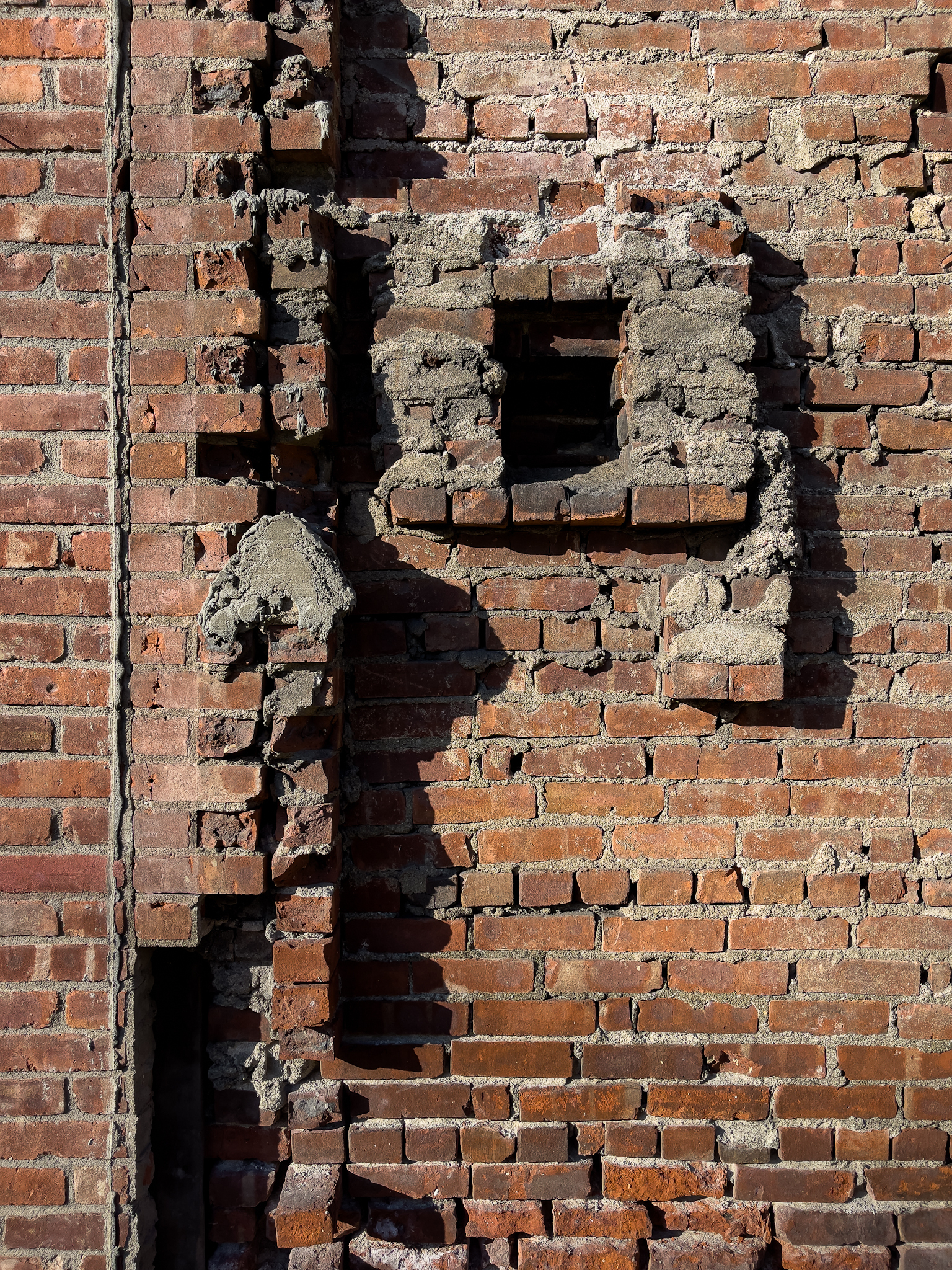 Brick wall with brick protrusions casting shadows.