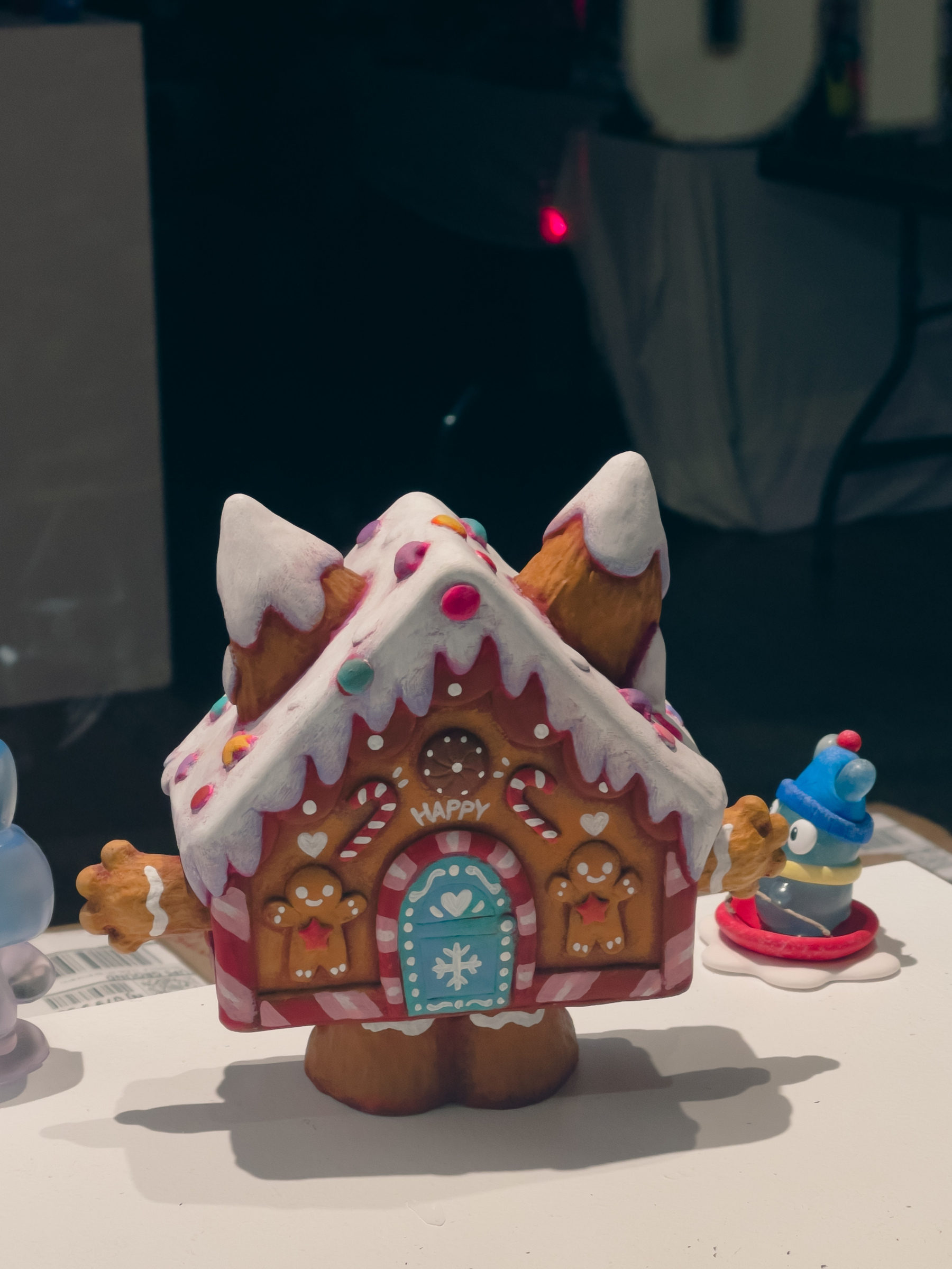 Gingerbread house toy in shop window.
