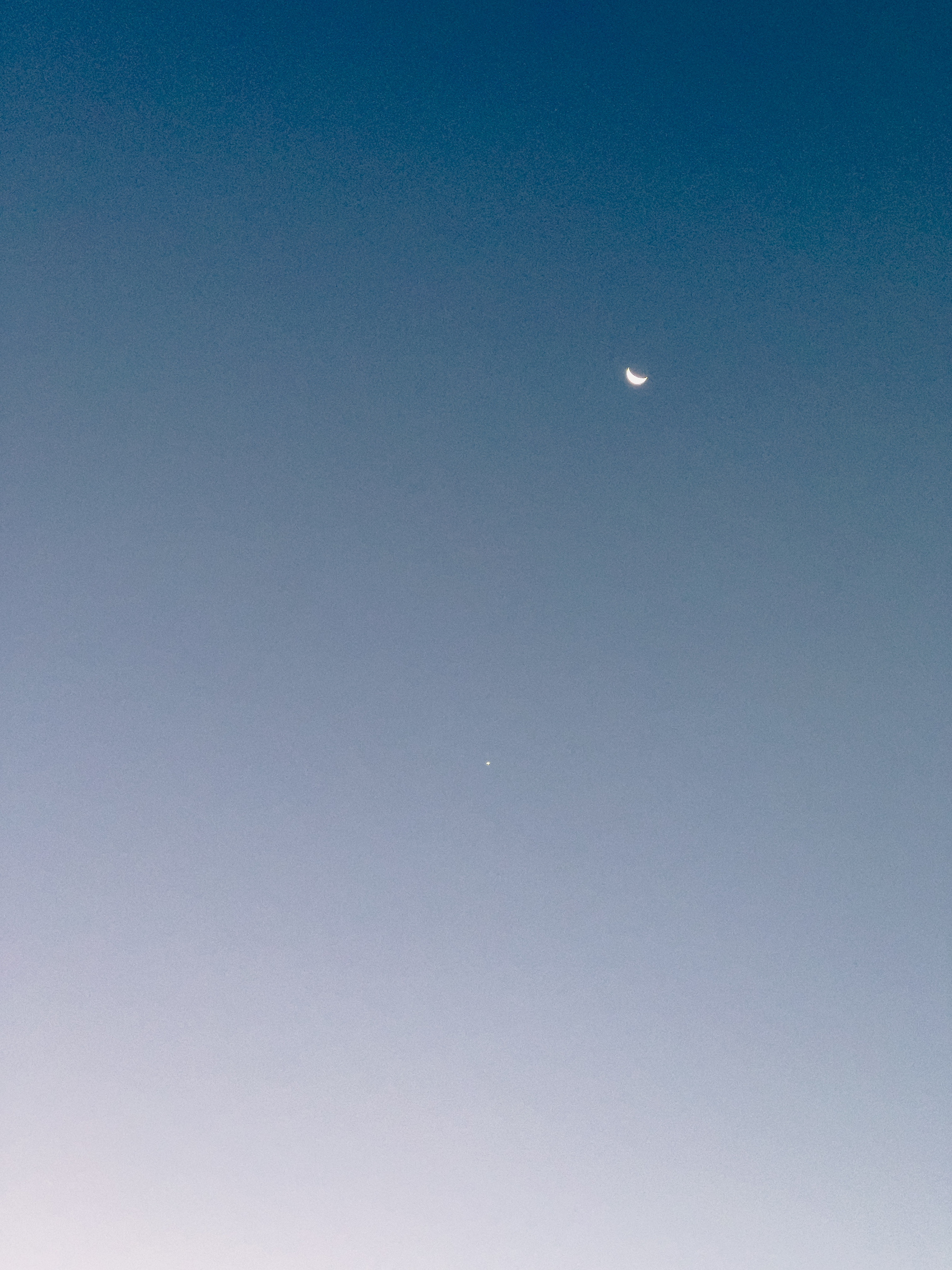 Venus and crescent moon in early morning sky.