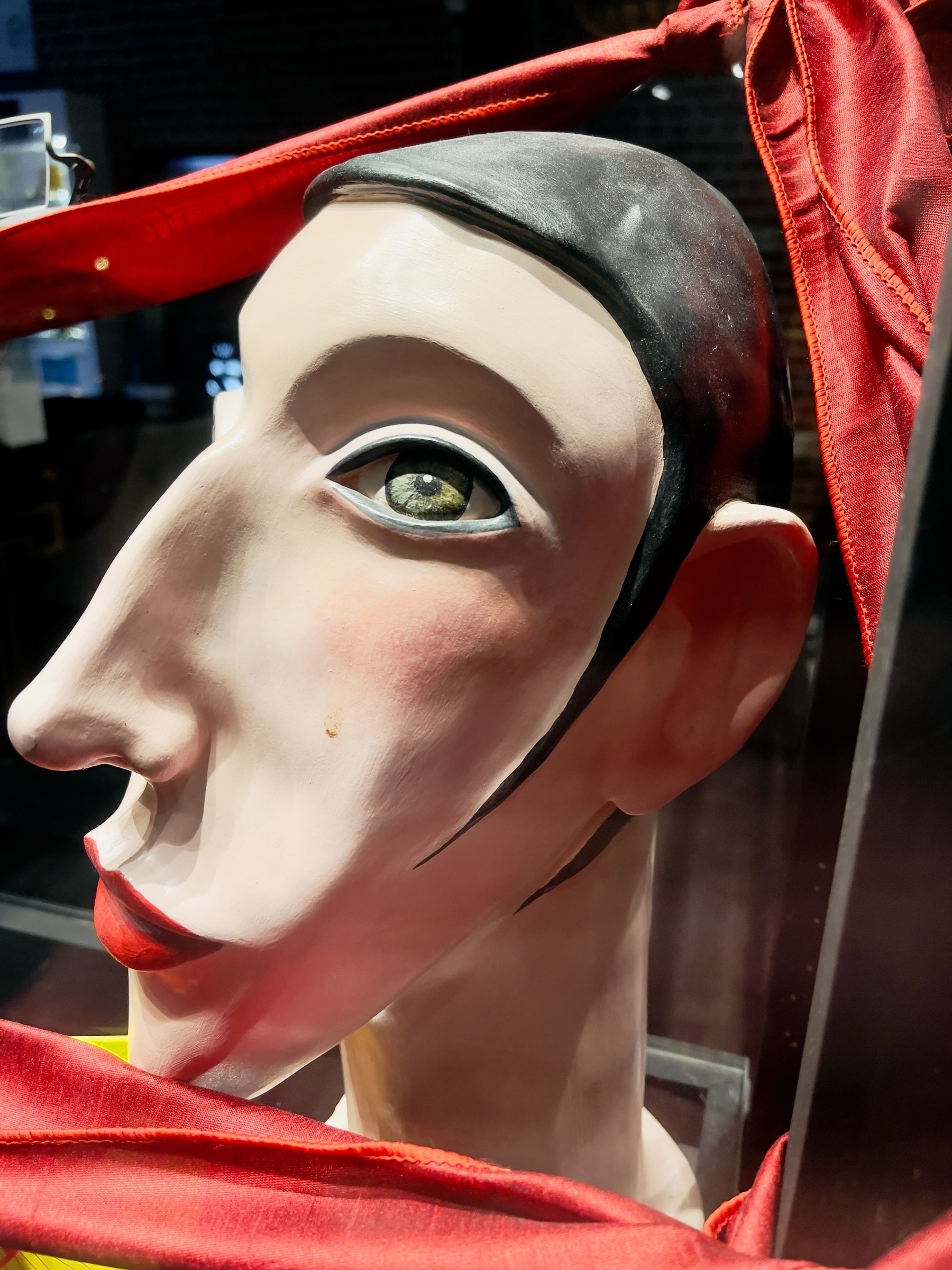 Stylized bust of woman in a shop window.
