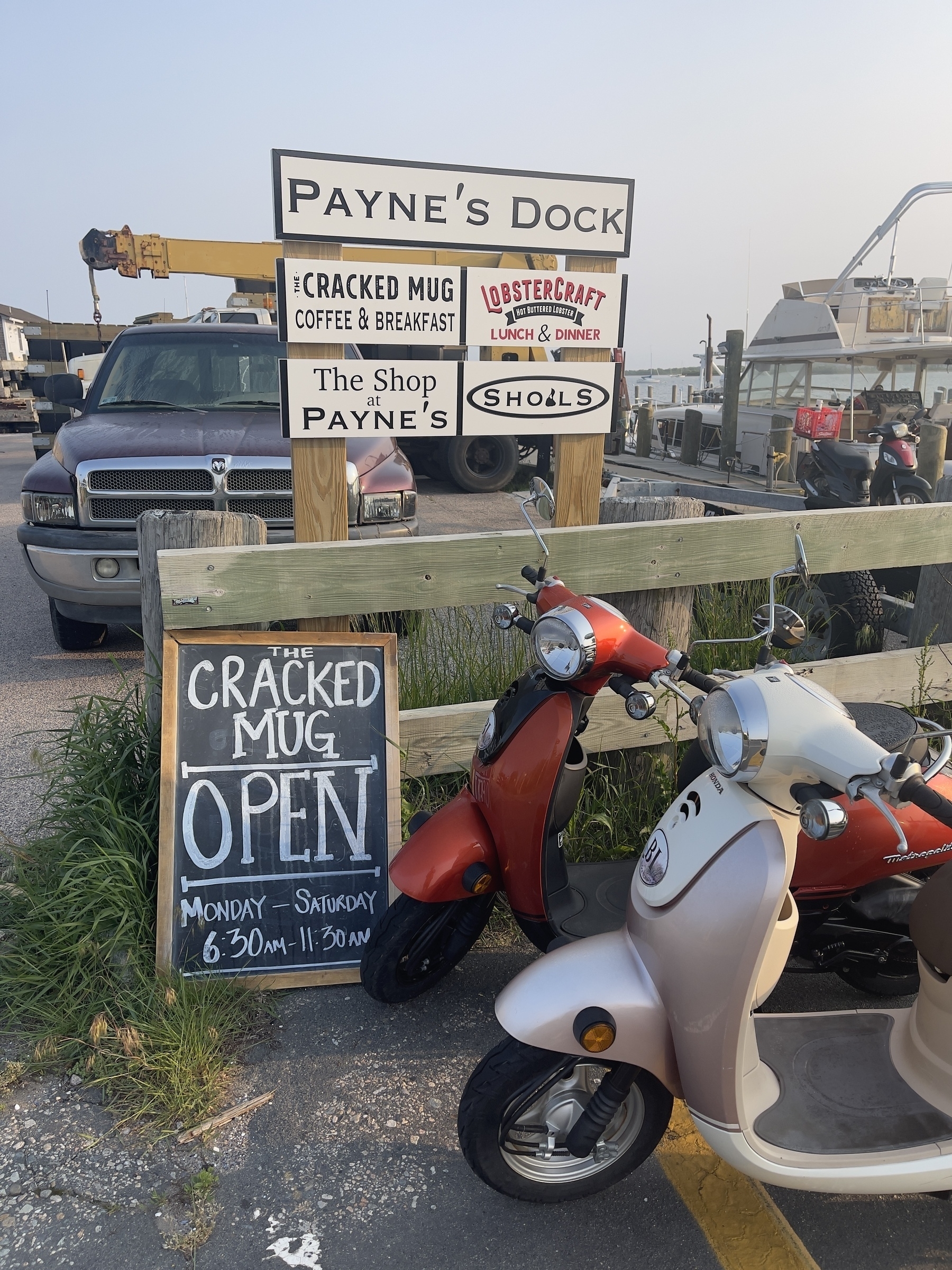 Mopeds and signage for businesses at Payne’s Dock including The Cracked Mug, source of my morning coffee.
