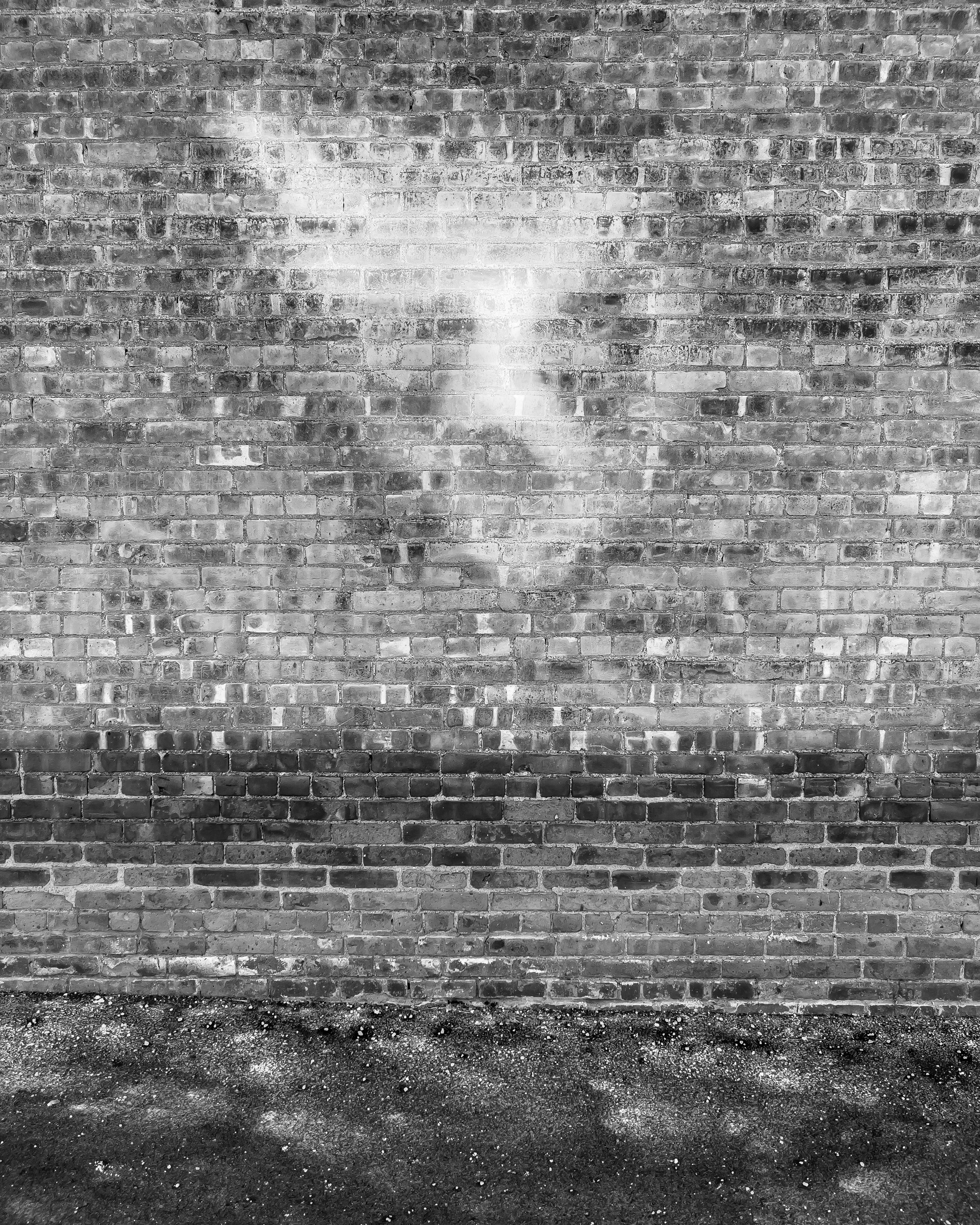 Face on brick wall created by reflected sunlight.