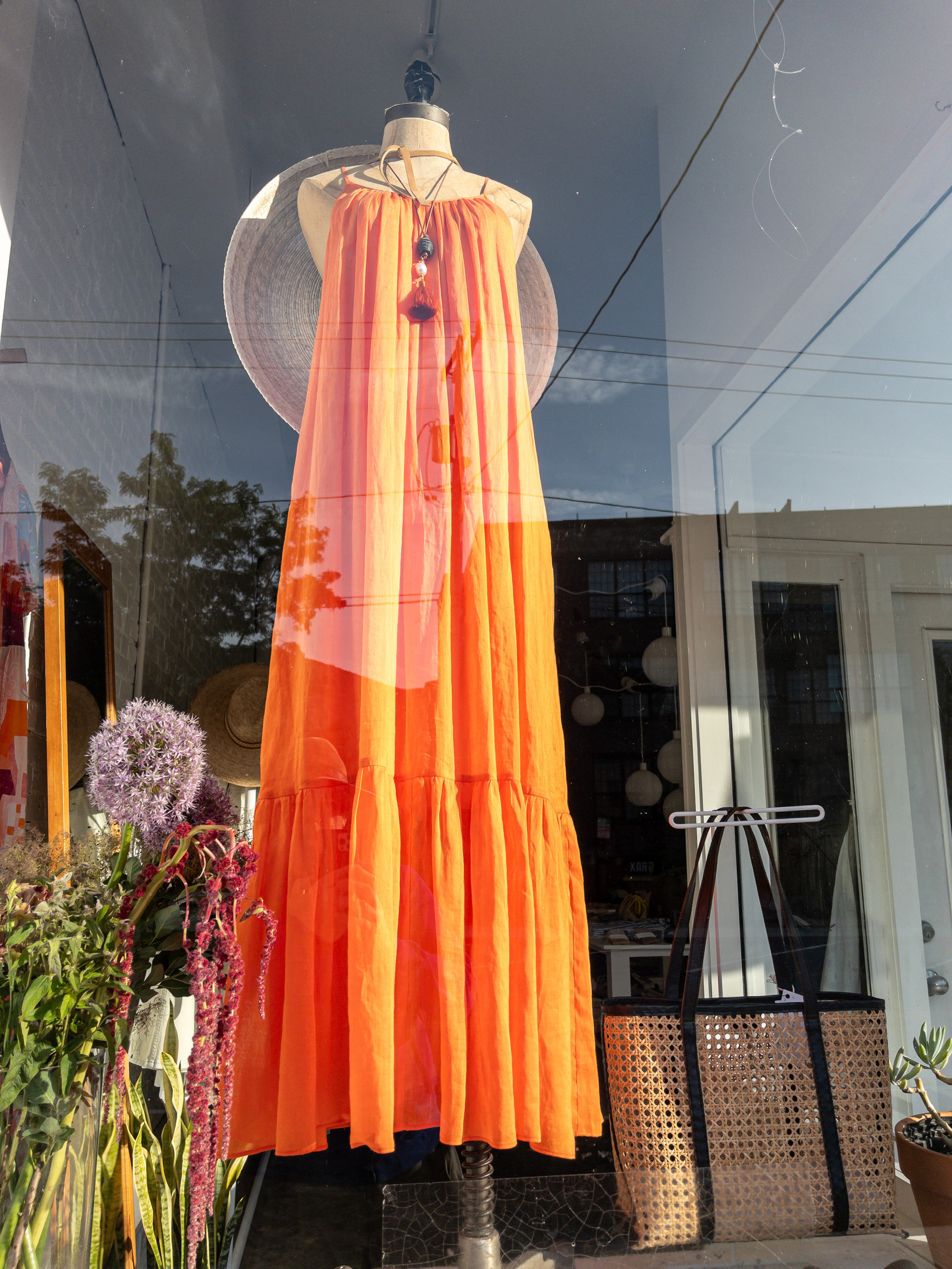 Orange sun dress in a shop window.