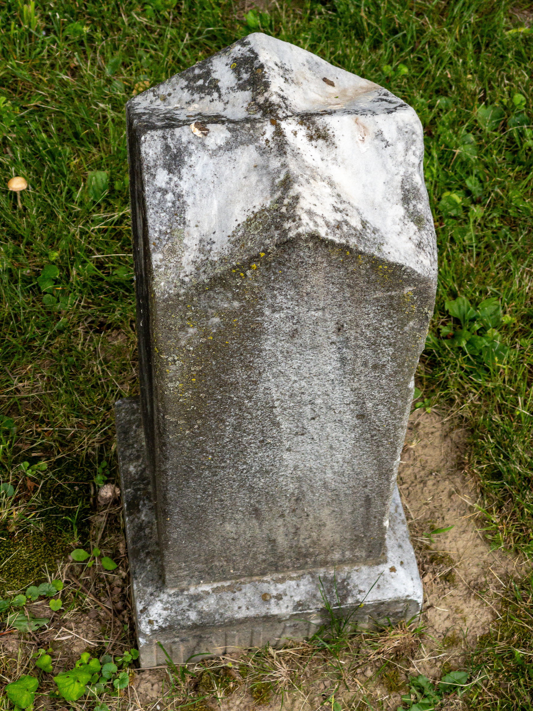 Stone grave marker in shape of obelisk.