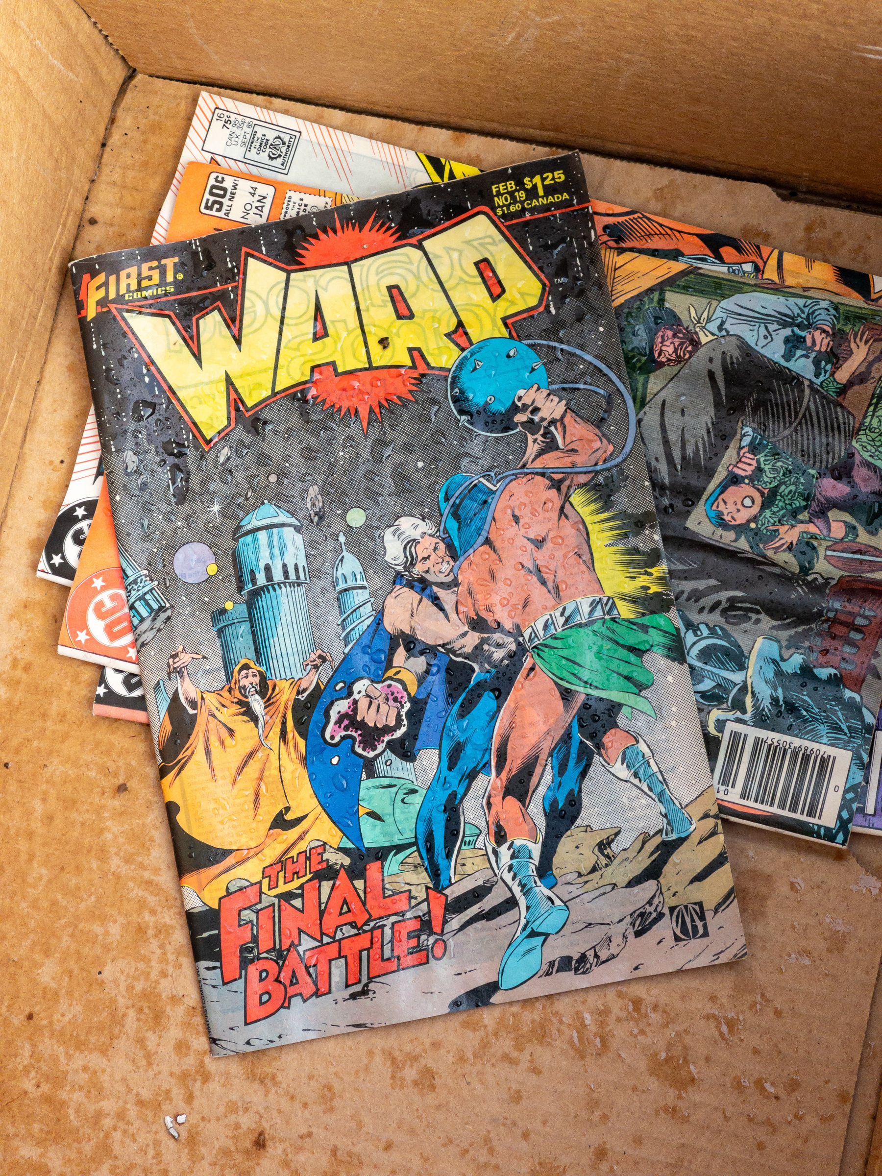 First warp comic book in a brown cardboard box.