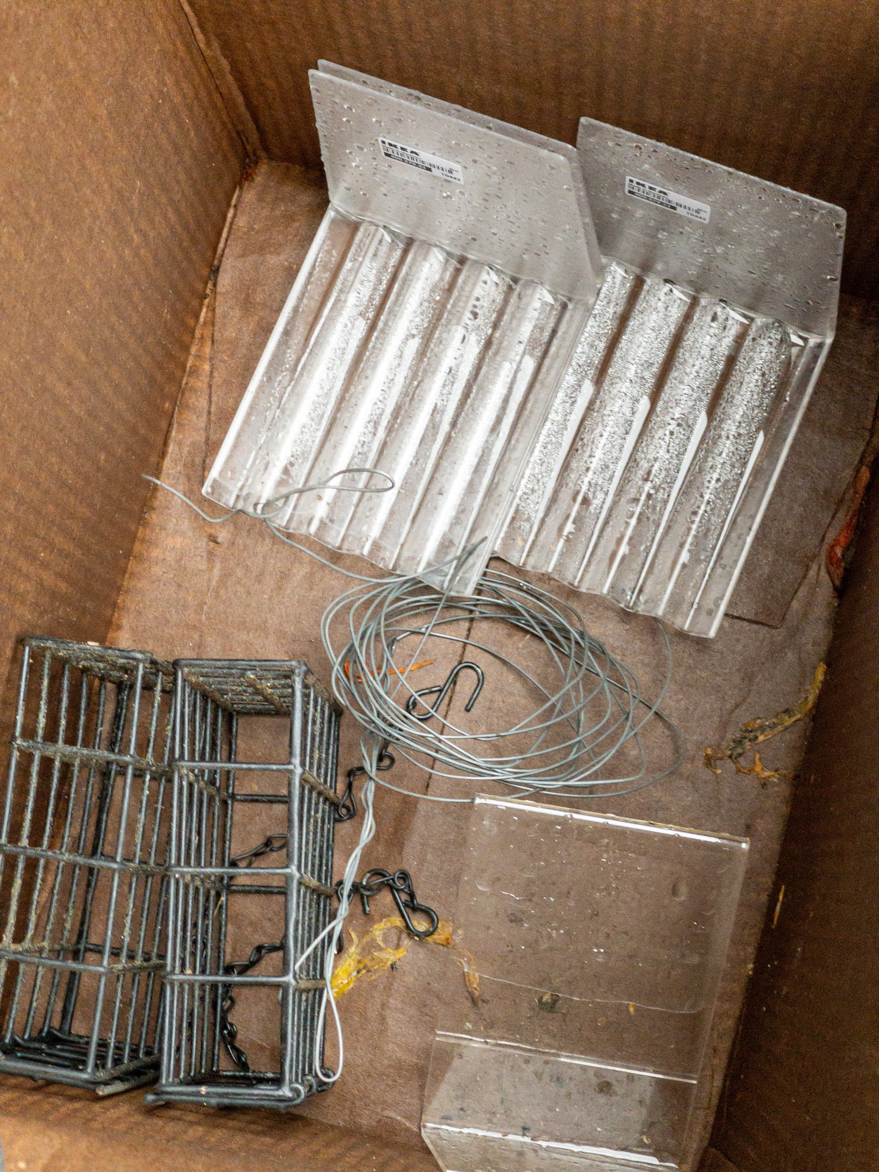 Things, plastic and metal, in a cardboard box.