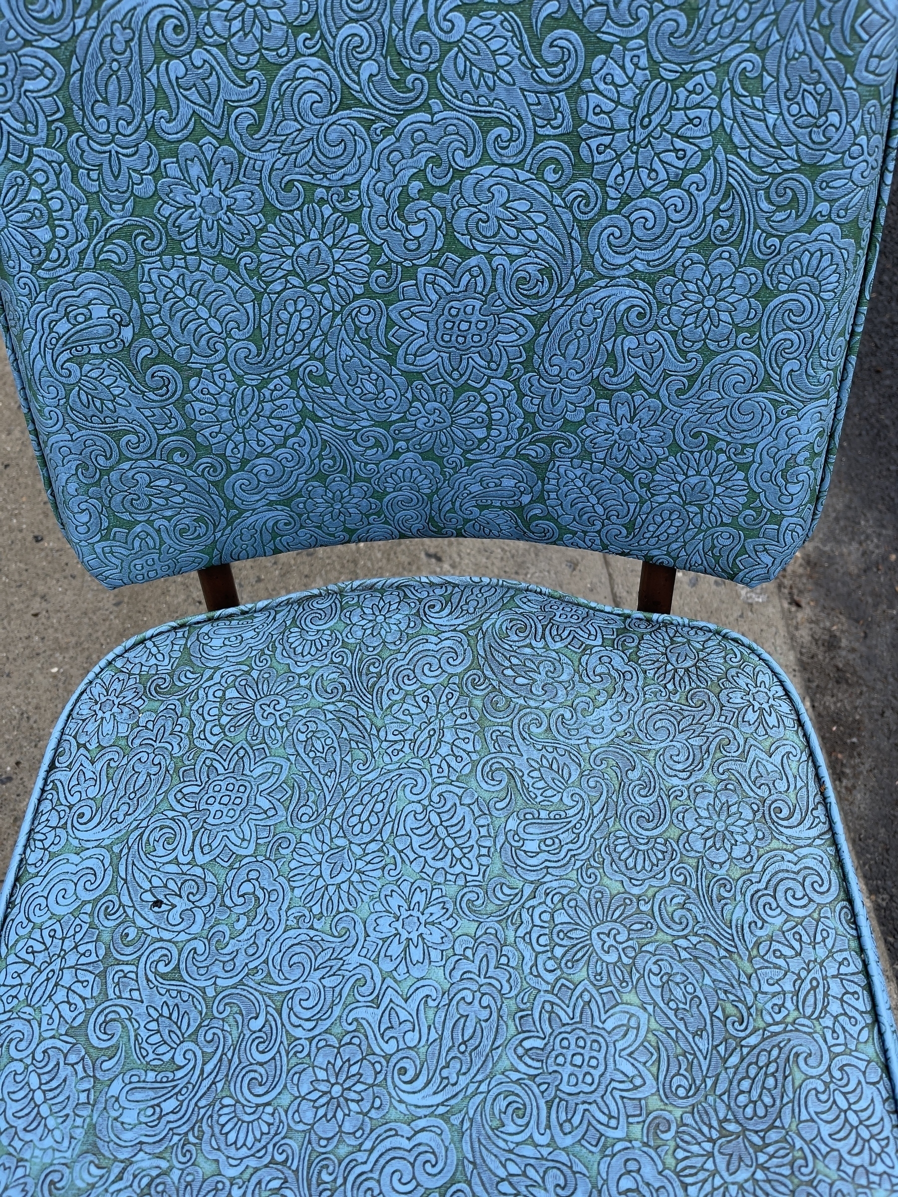 Blue vinyl plastic chair seat cushions with embossed paisley design.