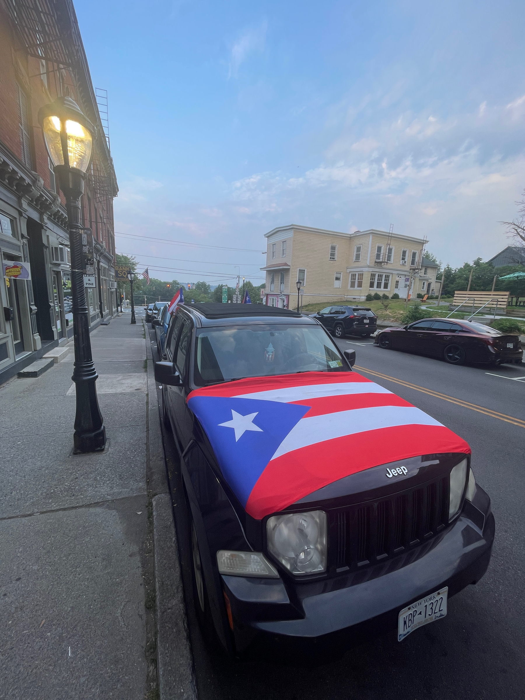 Car with Puerto Rican flag plastered to hood.