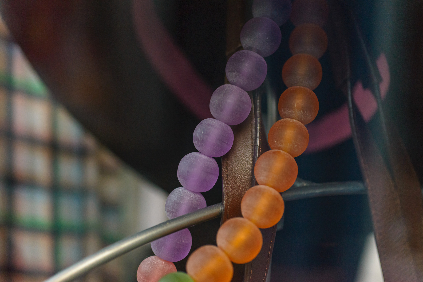 Purple and orange matte finish large scale beaded neckless in a shop window.
