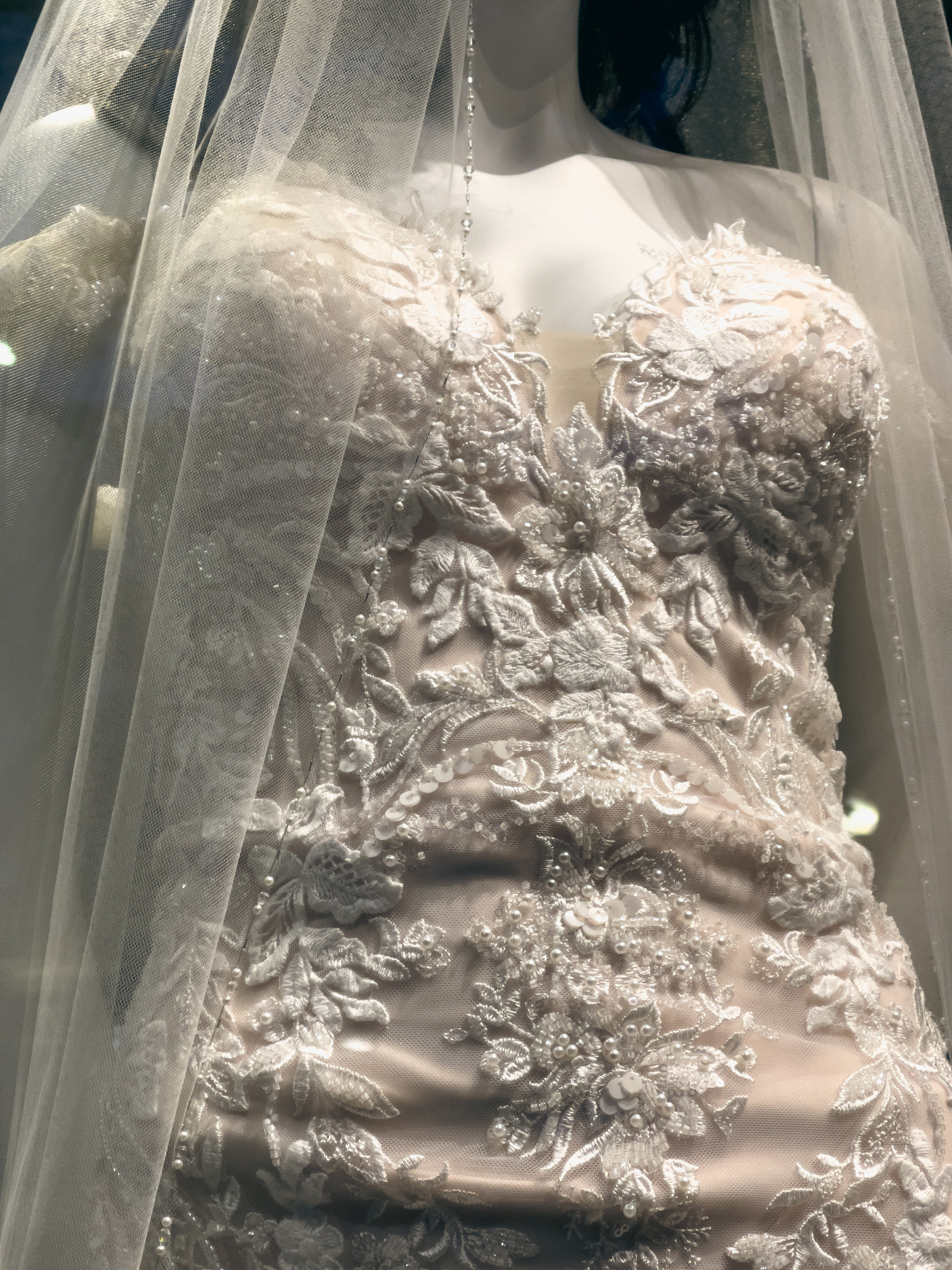 Closeup of wedding dress on a Mannequin from waist to bust line.