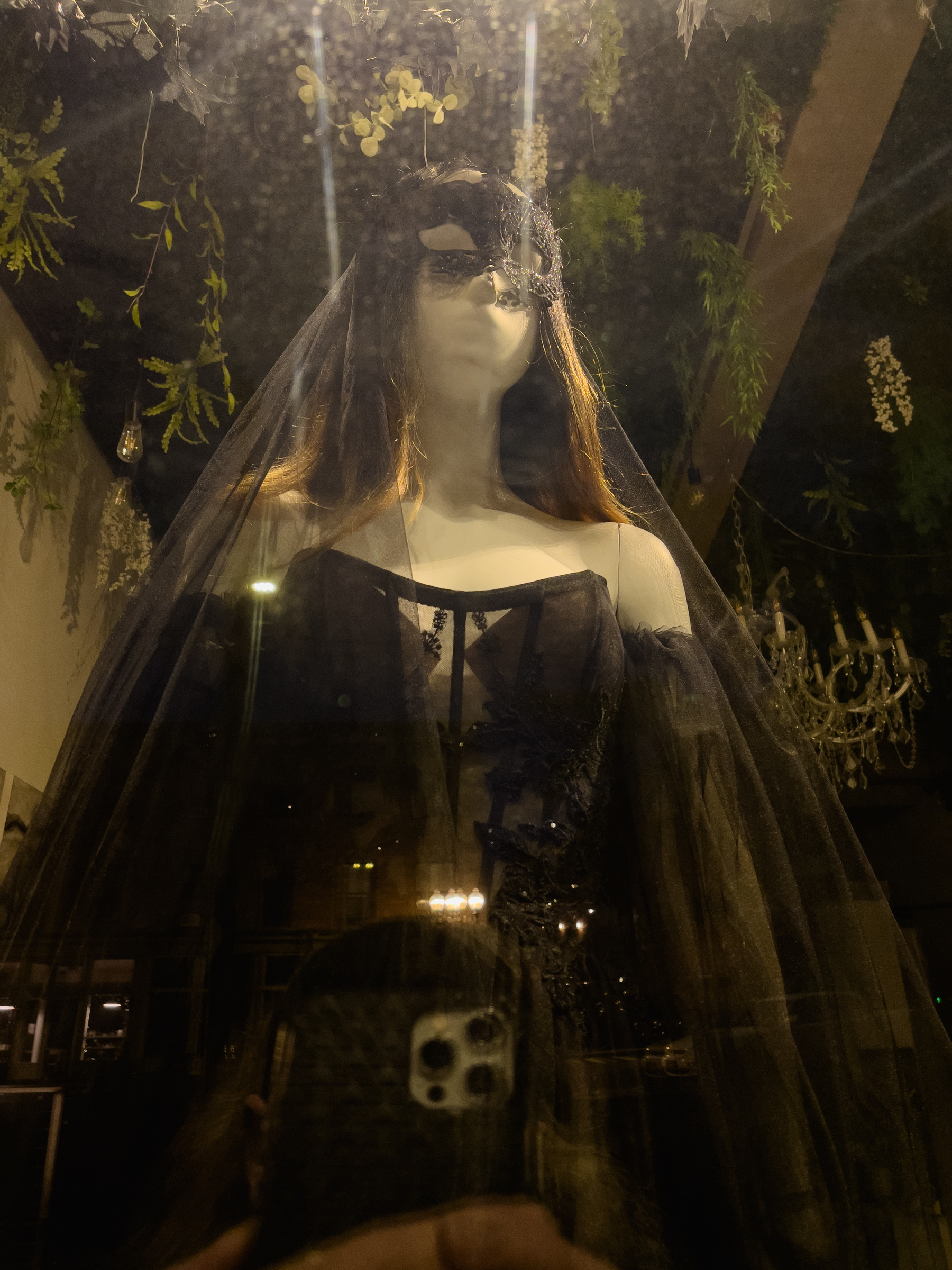 Black wedding dress in window of bridal boutique.