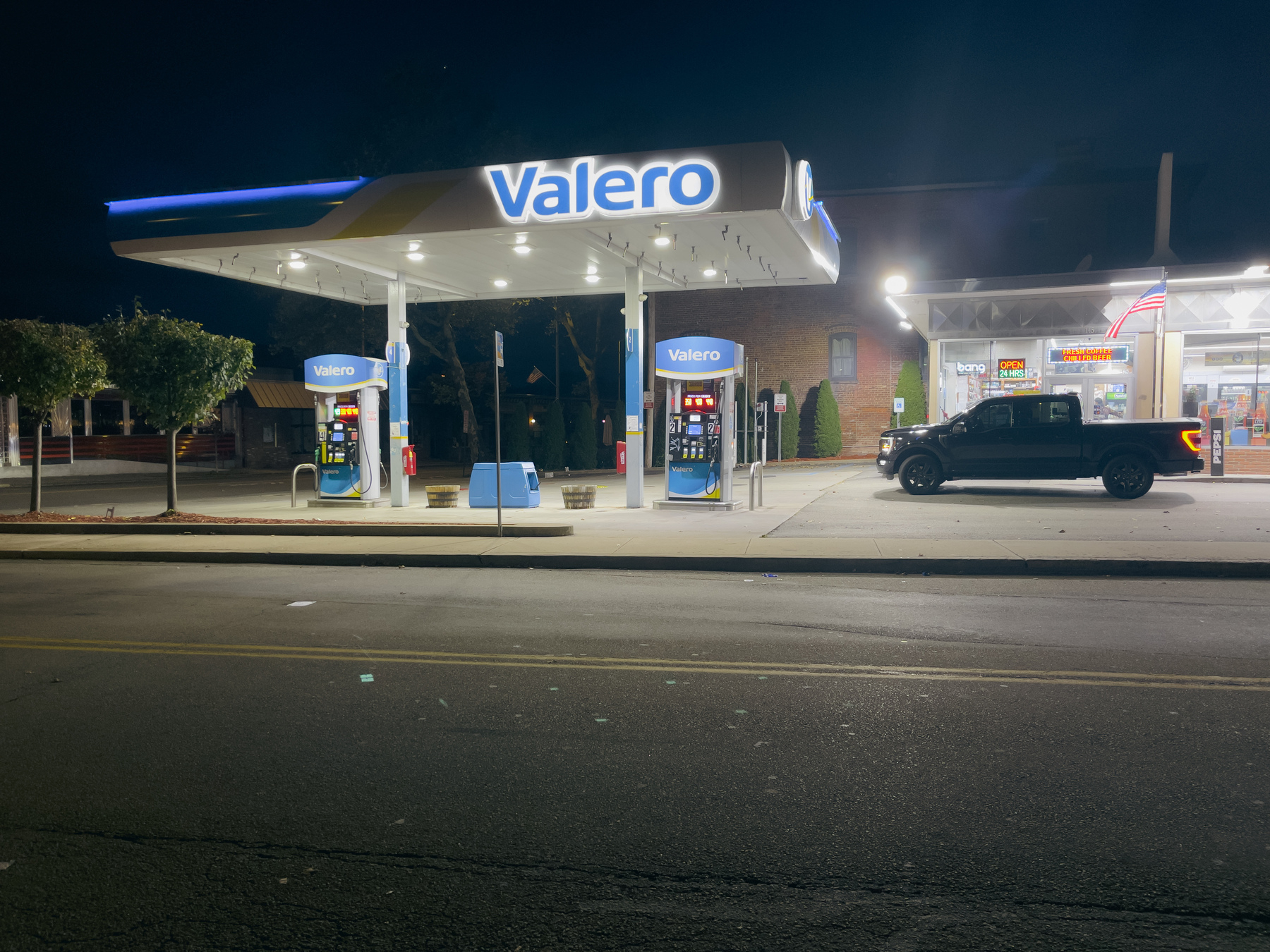 Valero gas station across the street at night.