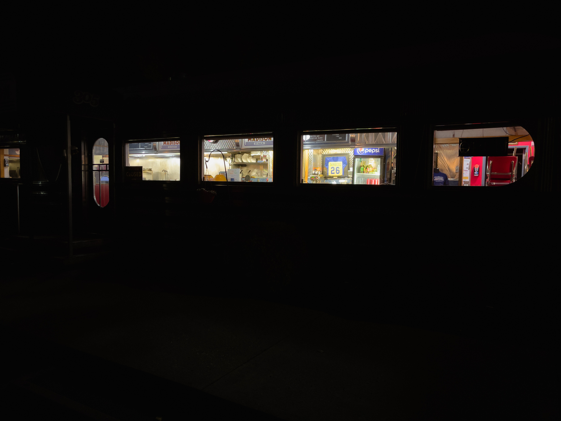 Windows of diner lit from within at night.