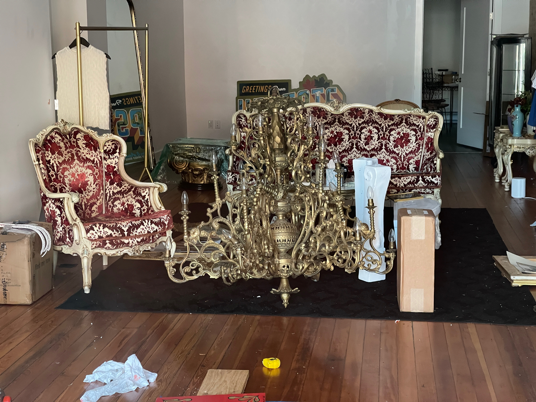 Baroque chair, sofa and chandelier in a shop getting ready to open.