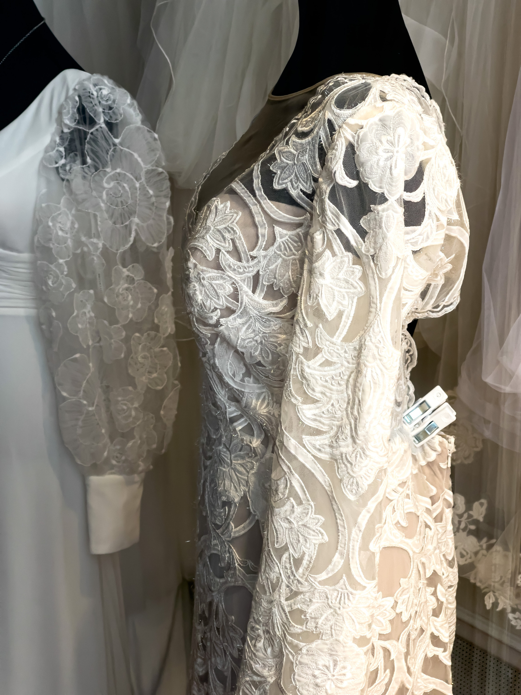 Lace wedding dresses in a bridal shop.