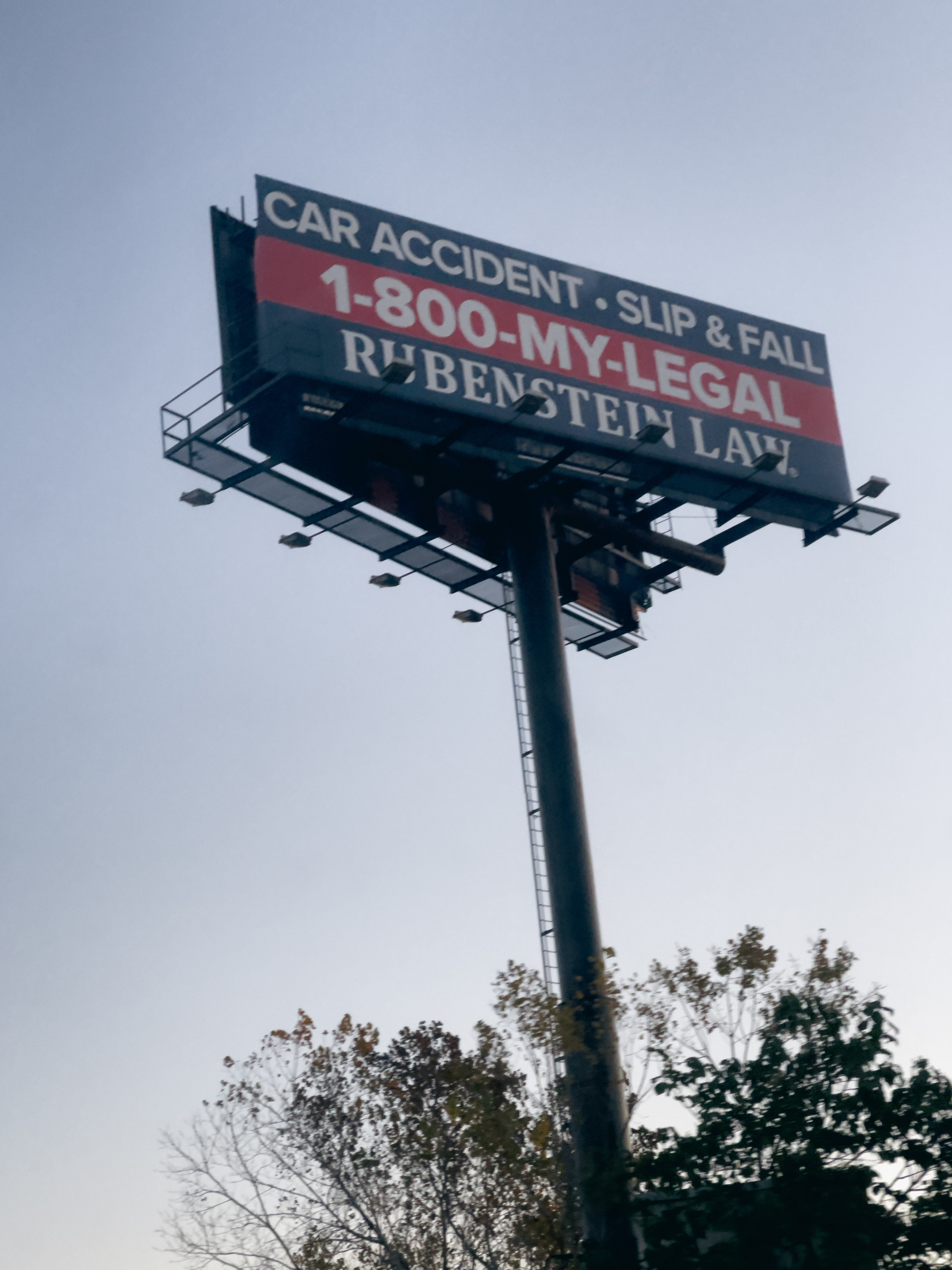 Billboard up on post advertising legal services for car accidents.