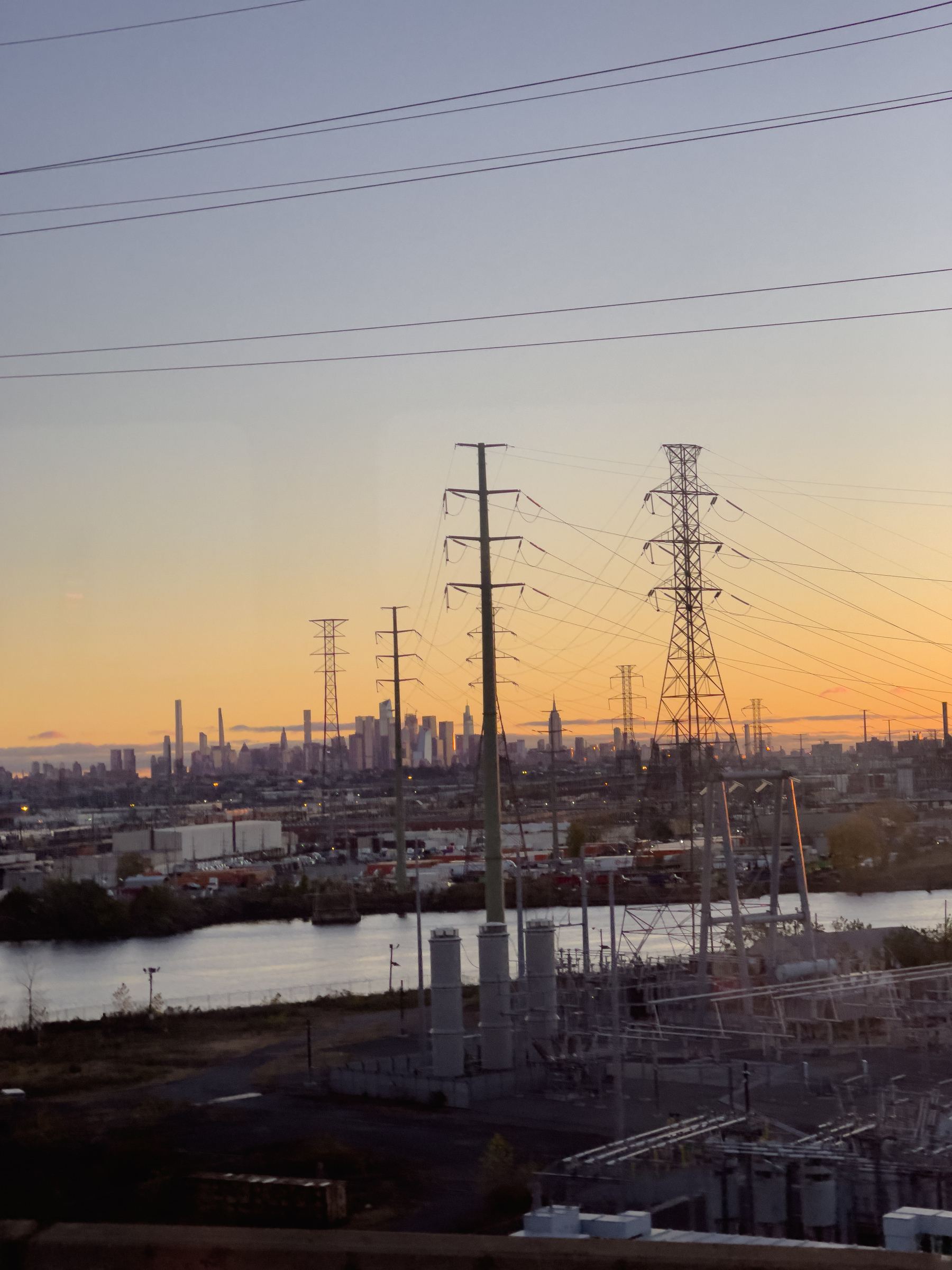 Industrial landscape with transmission towers in early morning light.