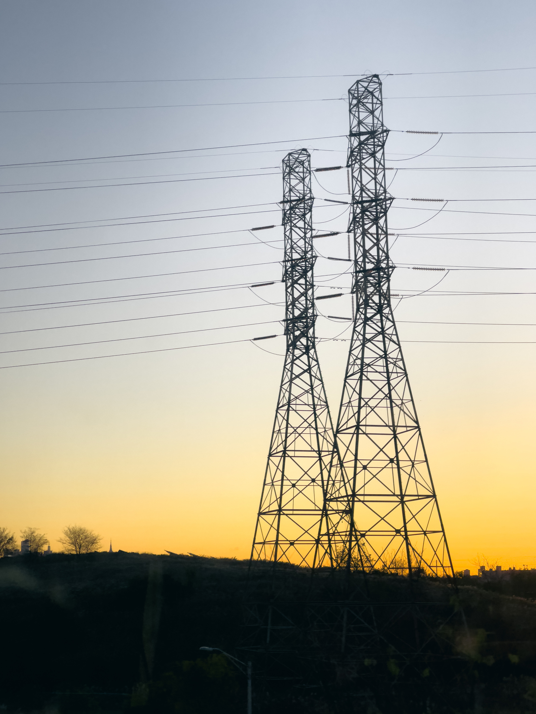 Transmission towers and wires at sunrise.
