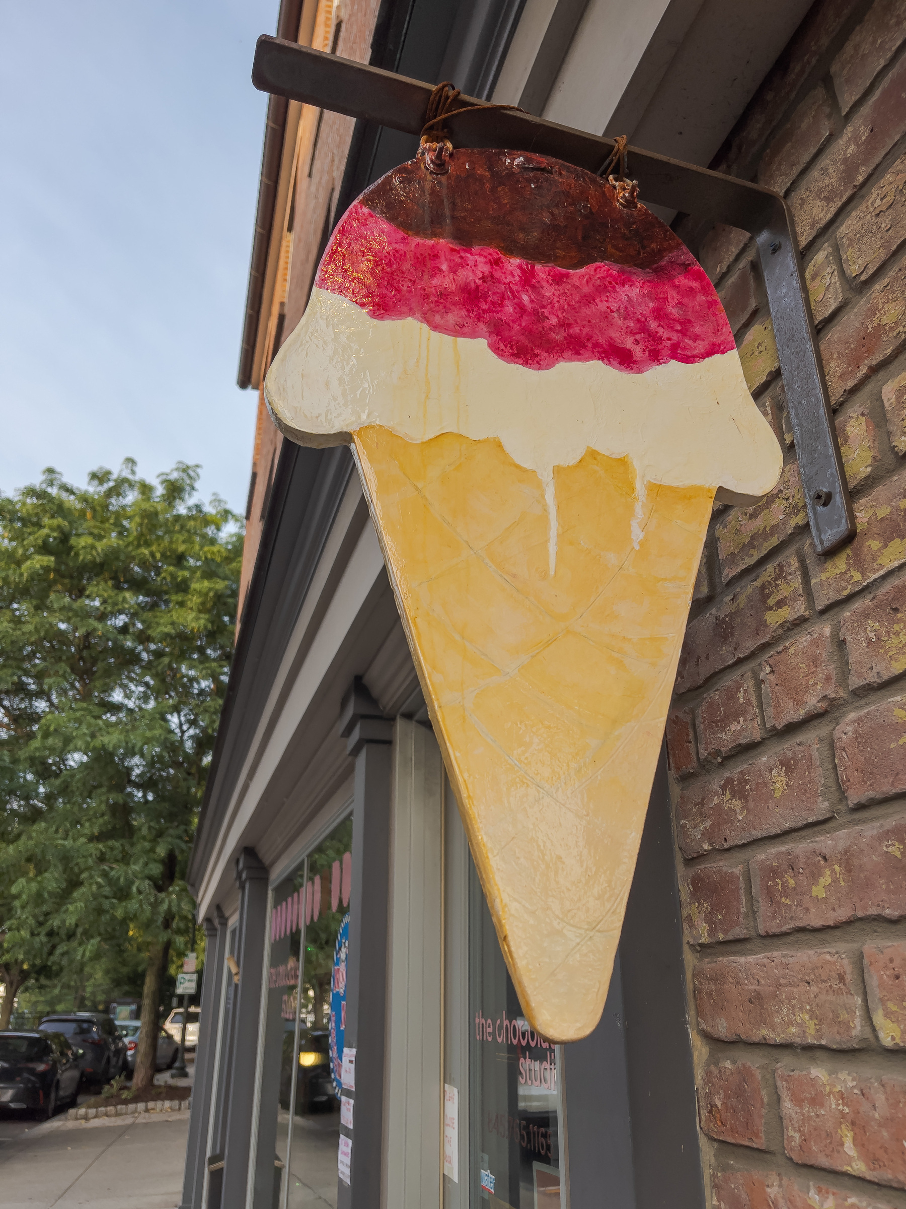 ice cream shop sign in shape of an ice cream cone
