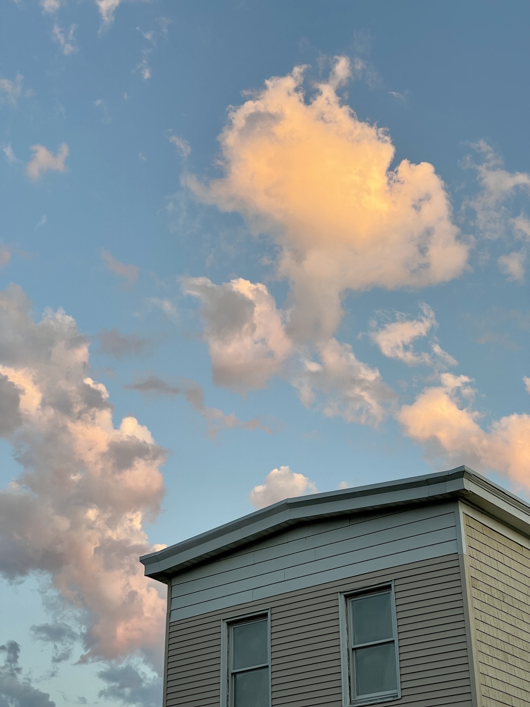 Sunrise clouds above a residential building.